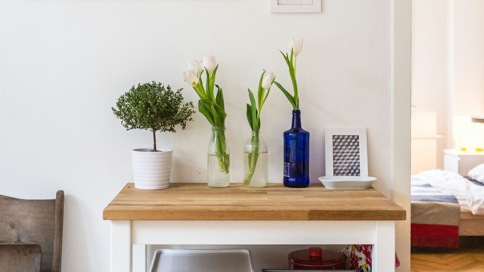 white and brown wooden end table near wall inside room