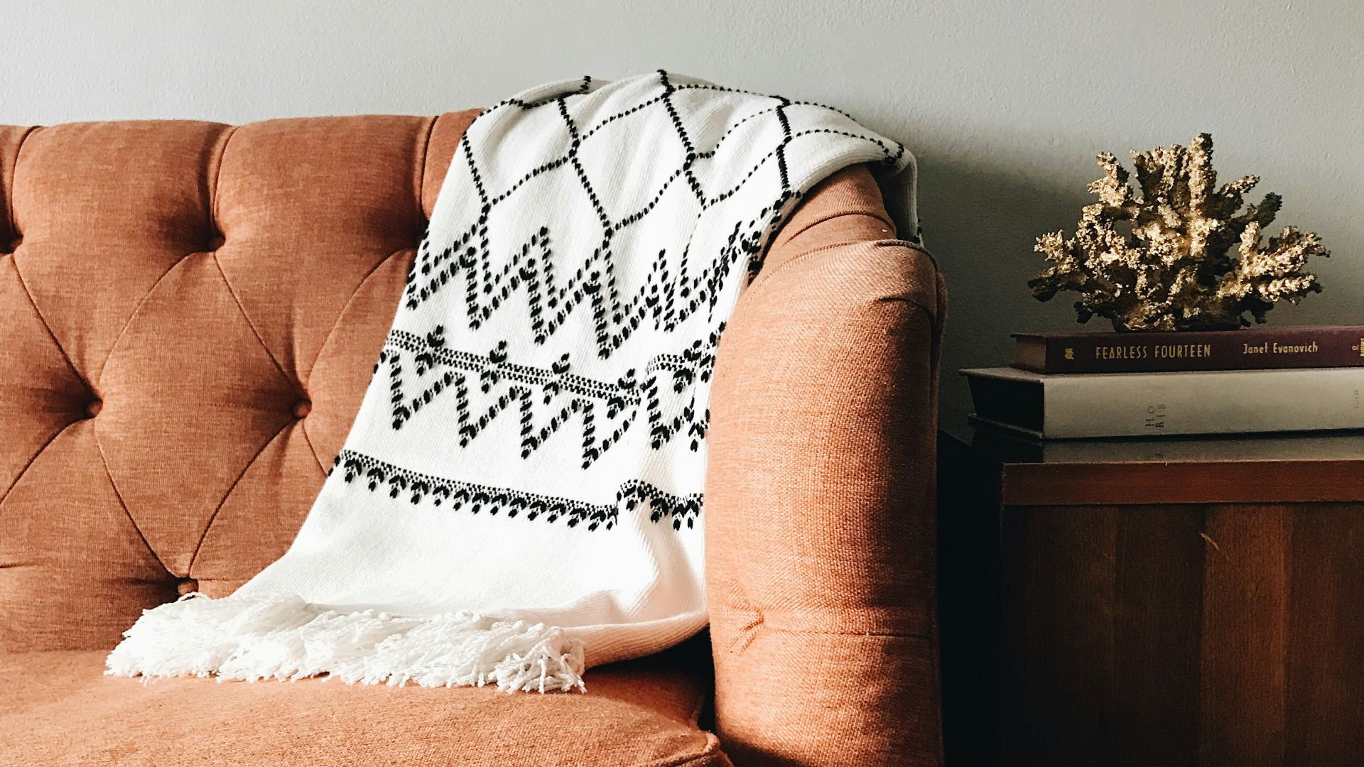 white and black textile on brown couch
