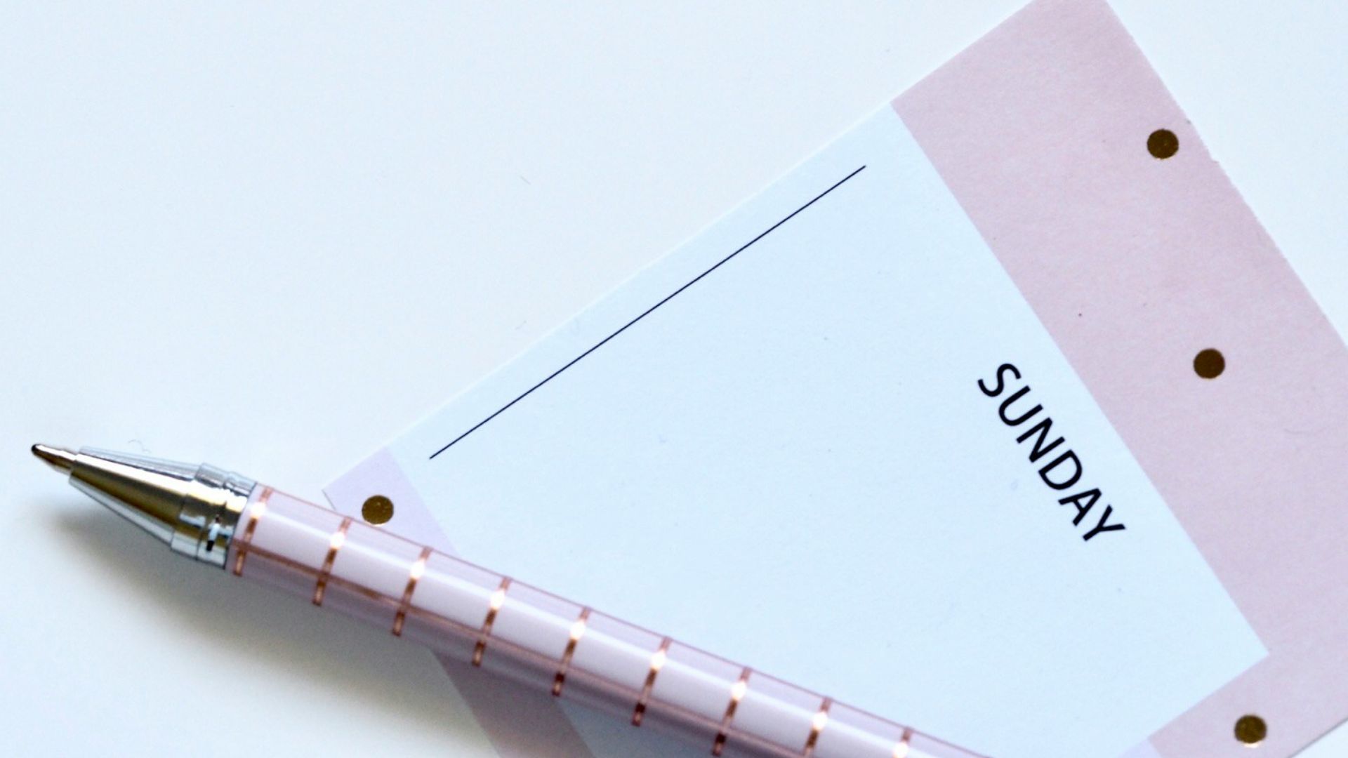 eyeglasses near paper and ballpoint pen