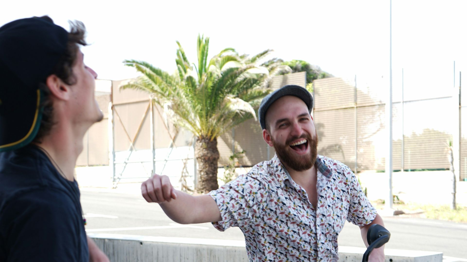 man in blue crew neck t-shirt standing beside woman in white and blue floral shirt