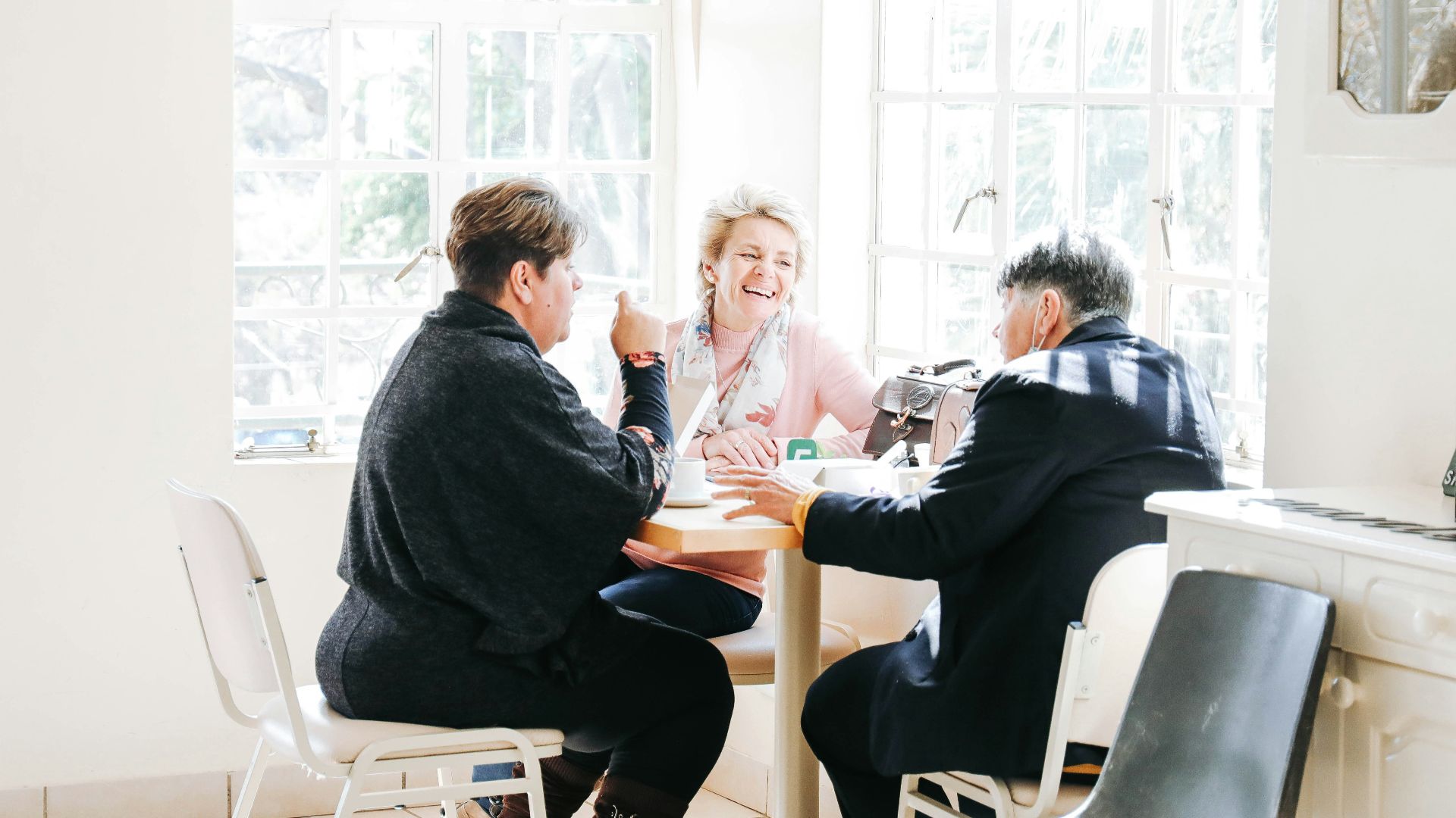 a group of people sitting around a table