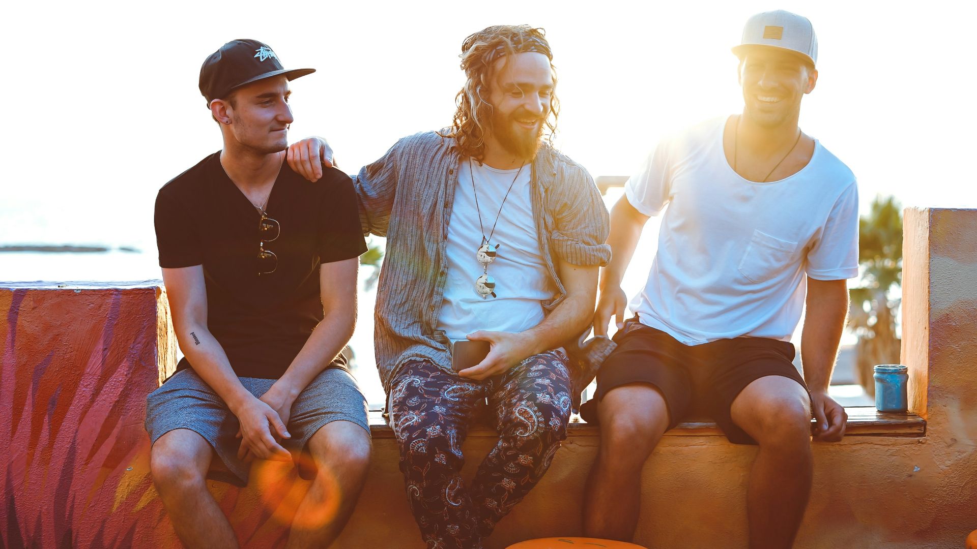 three man sitting on gray surface
