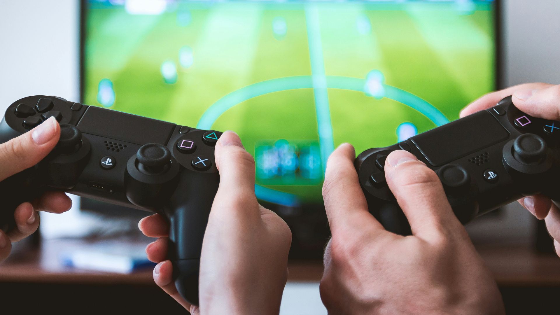 two people playing Sony PS4 game console