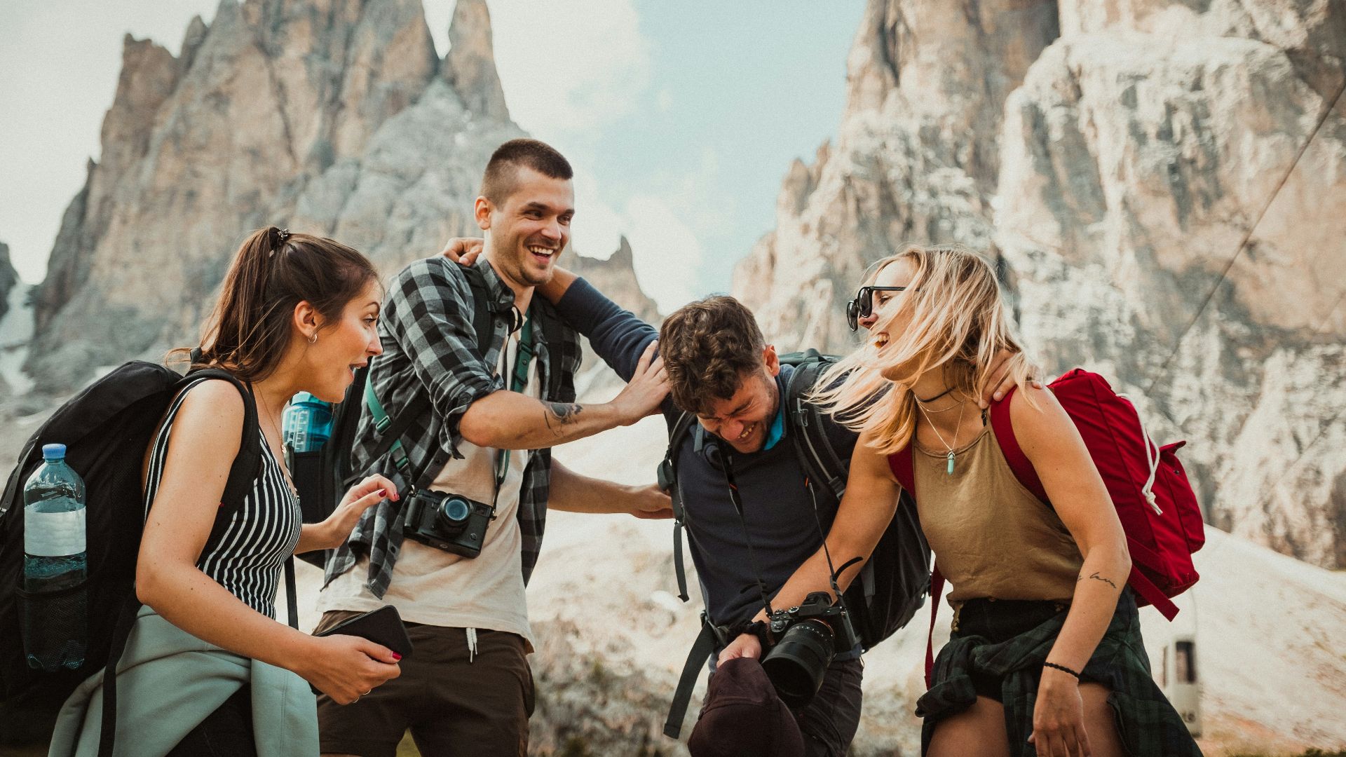 low-angle photography of two men playing beside two women