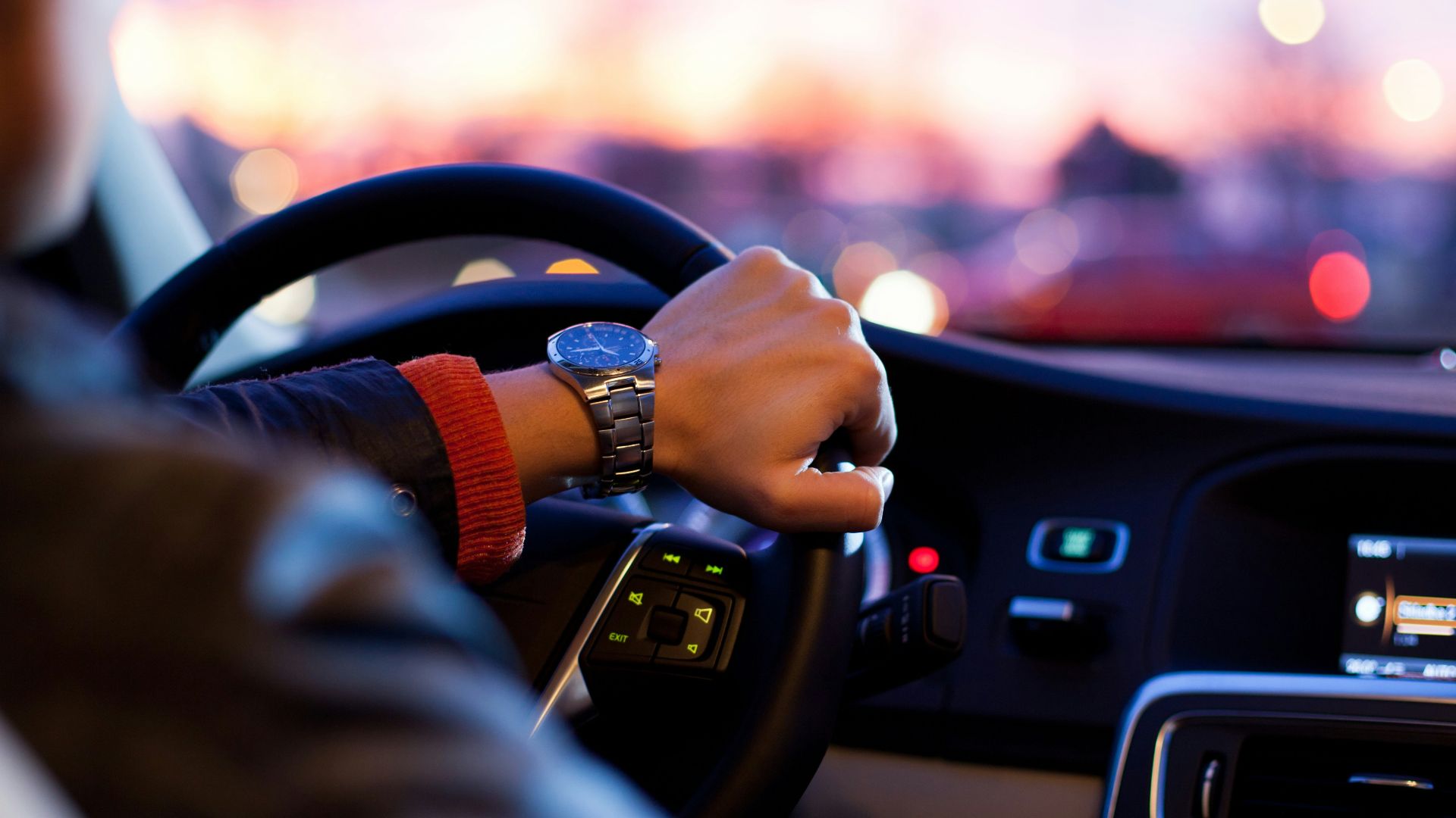 man driving a car wearing wrist watch