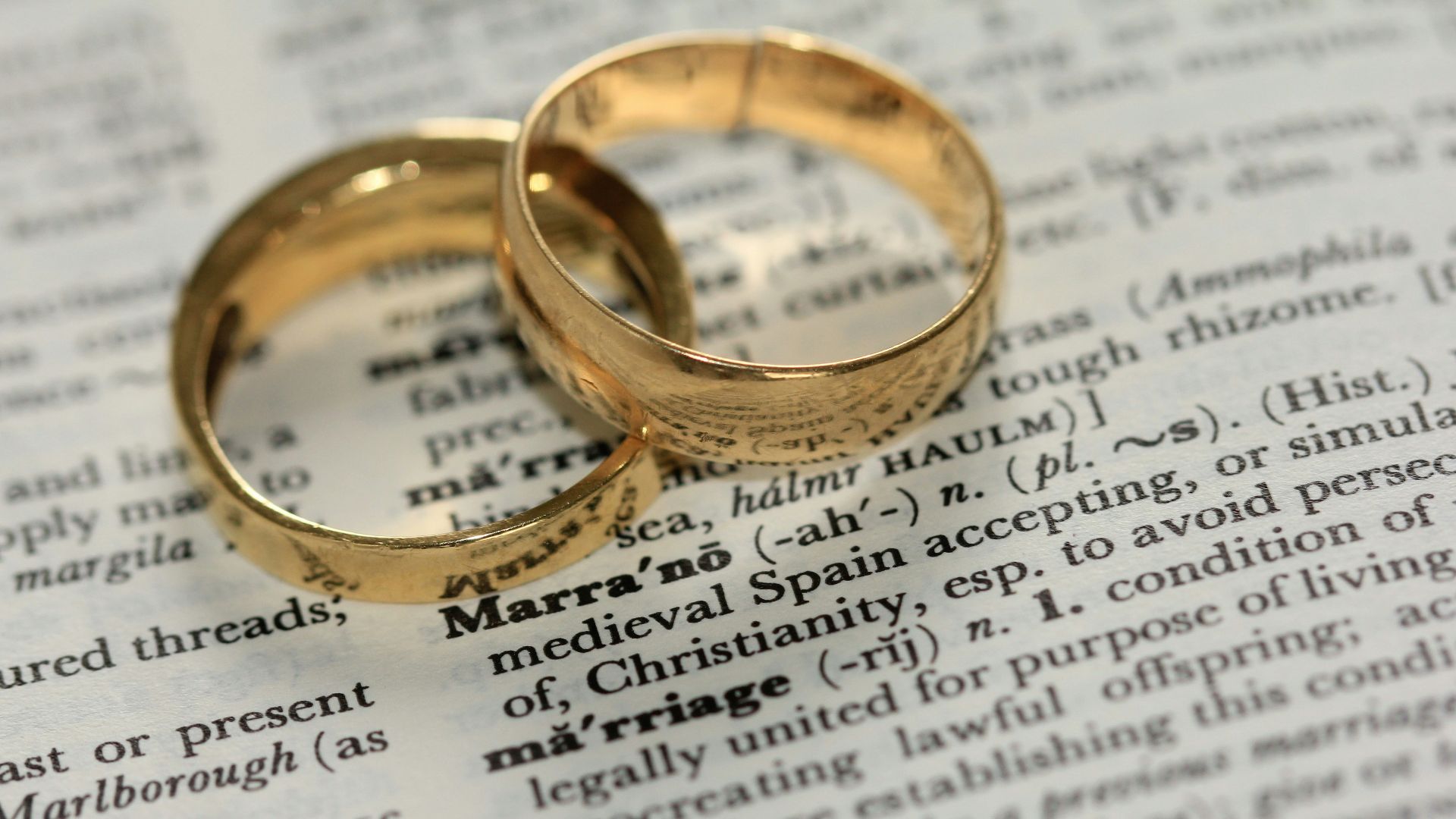 two gold-colored rings on paper
