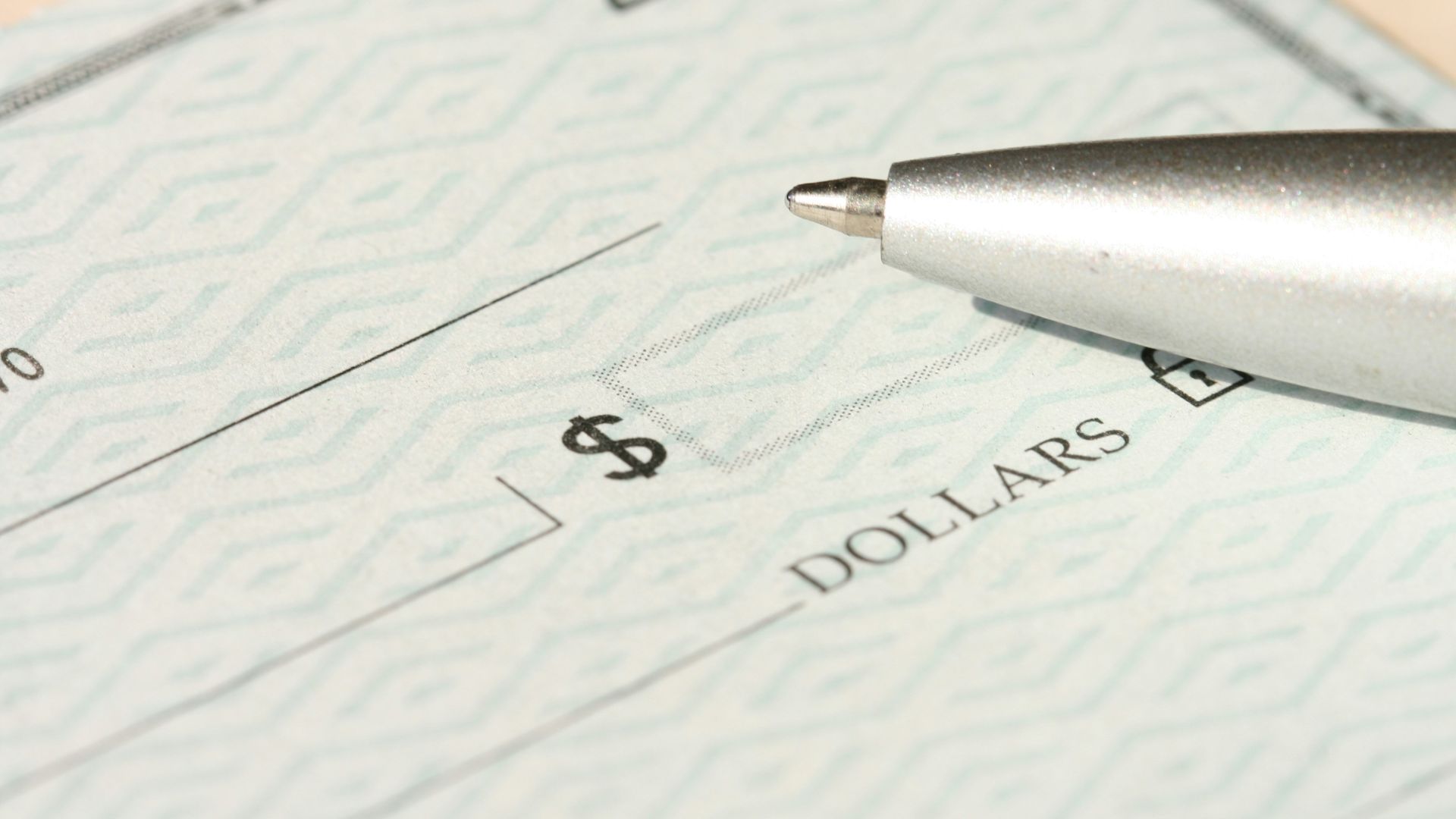 a pen sitting on top of a cheque paper