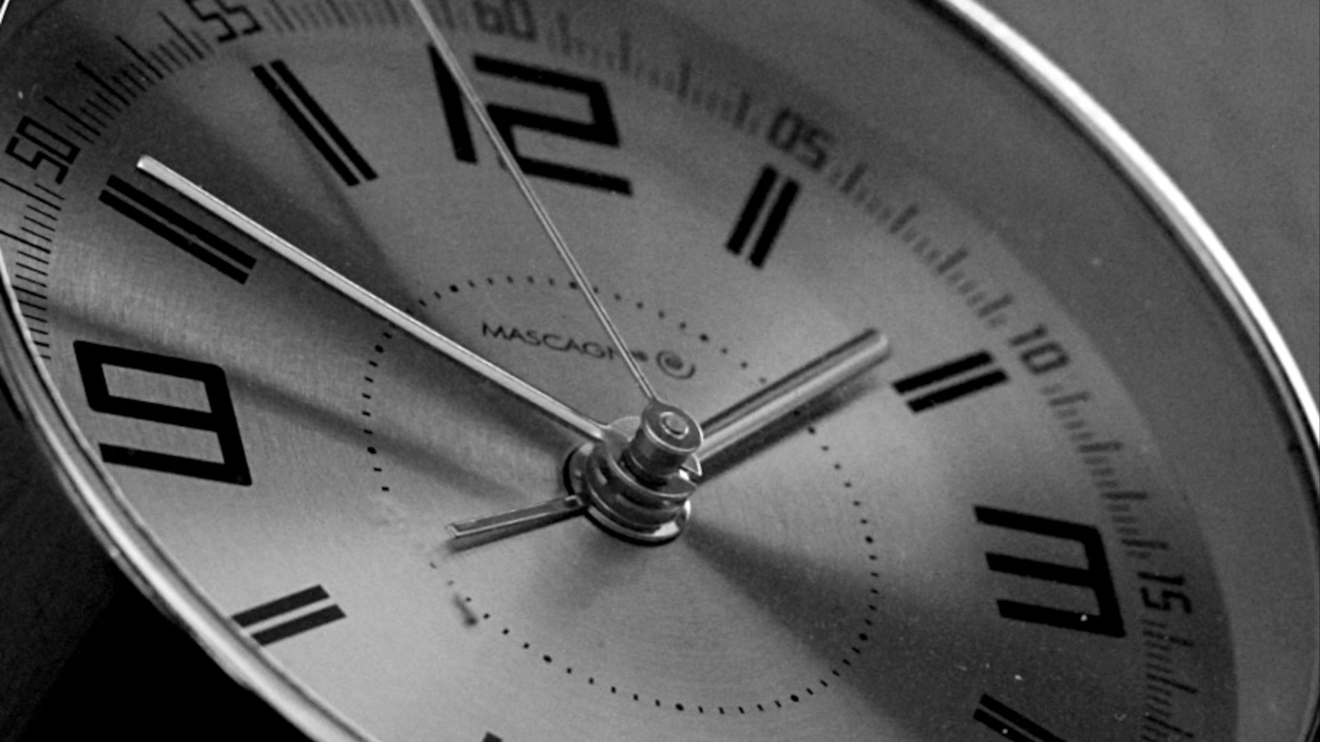 a black and white photo of a clock