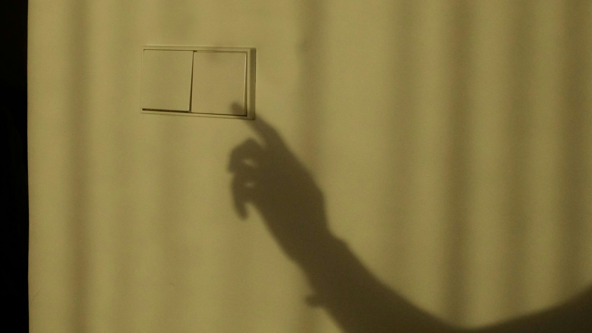 a shadow of a person holding a piece of paper