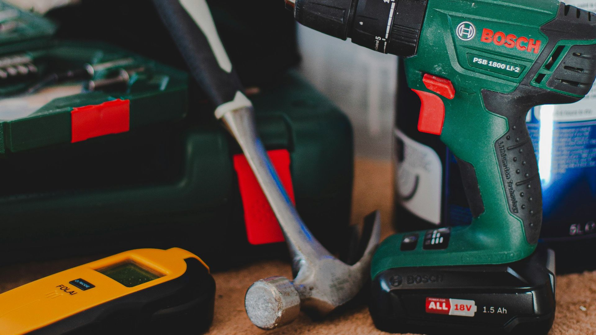 red and black cordless power drill beside black and red cordless power drill
