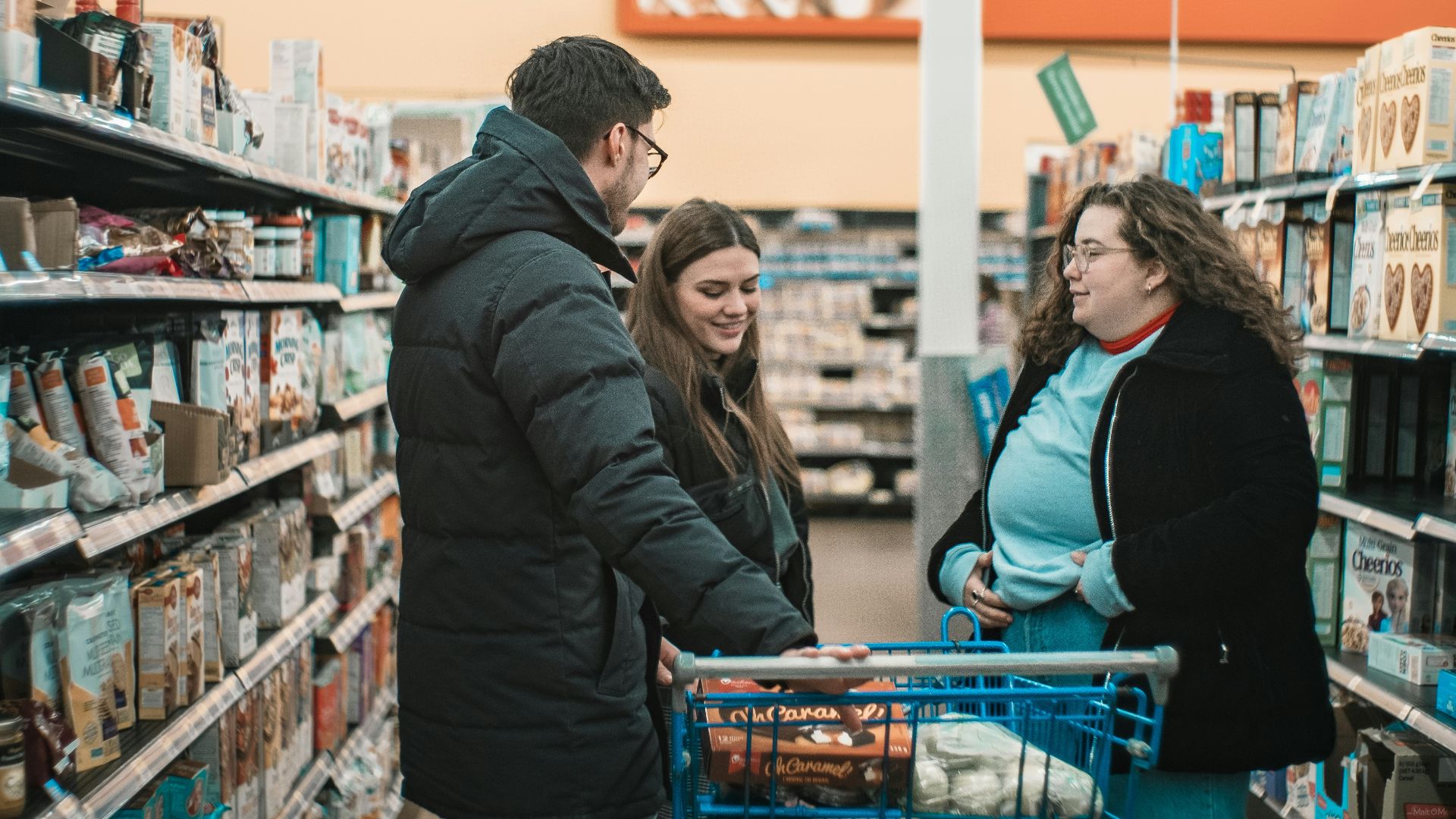 two men and man standing beside push cart