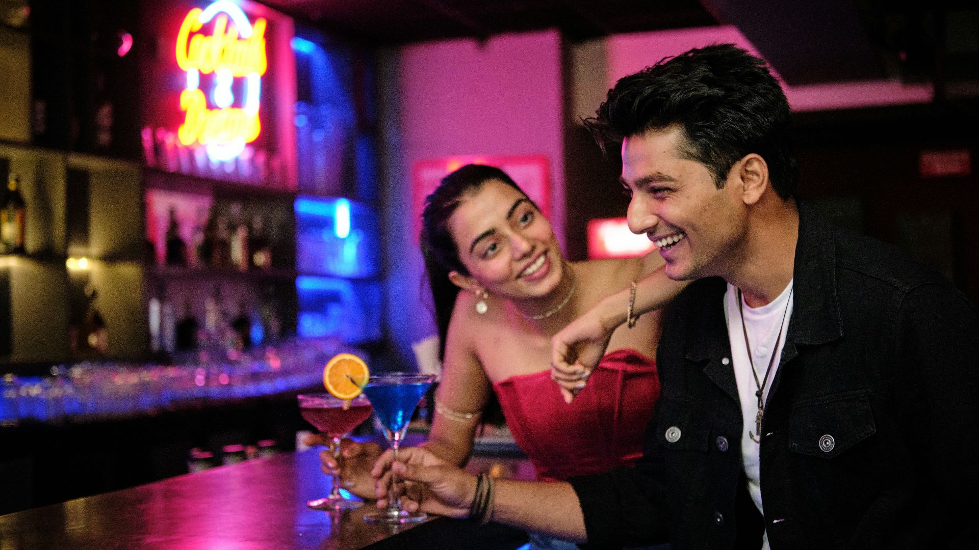 a man and a woman sitting at a bar