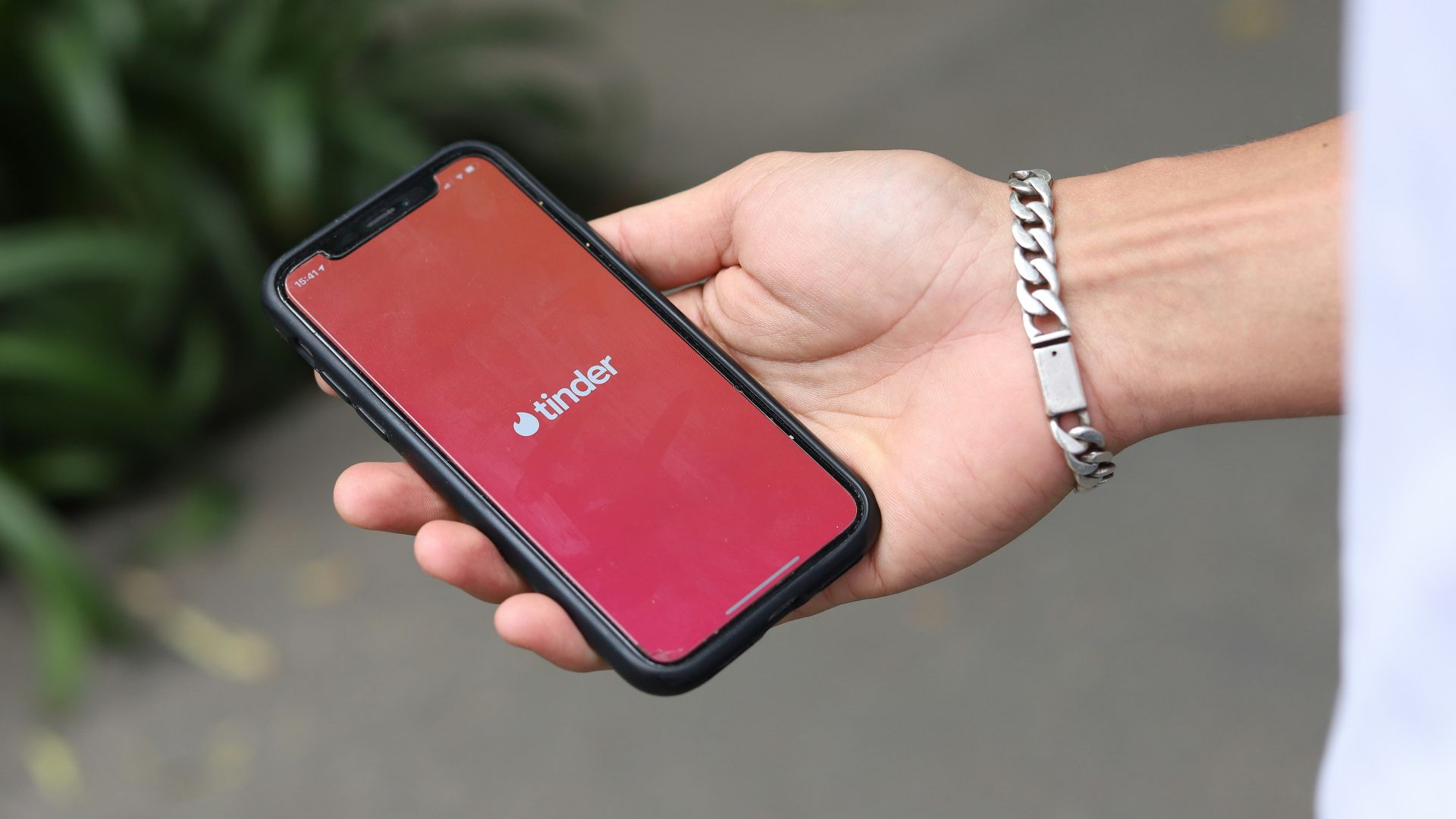 a person holding a red cell phone in their hand