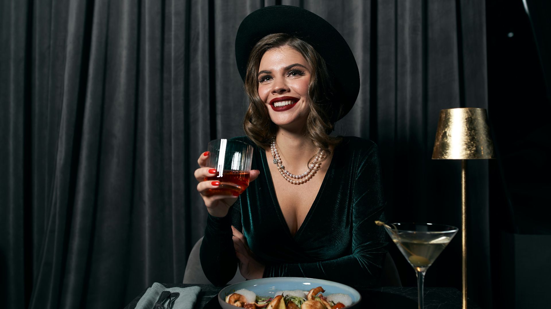 woman in black long sleeve shirt holding wine glass