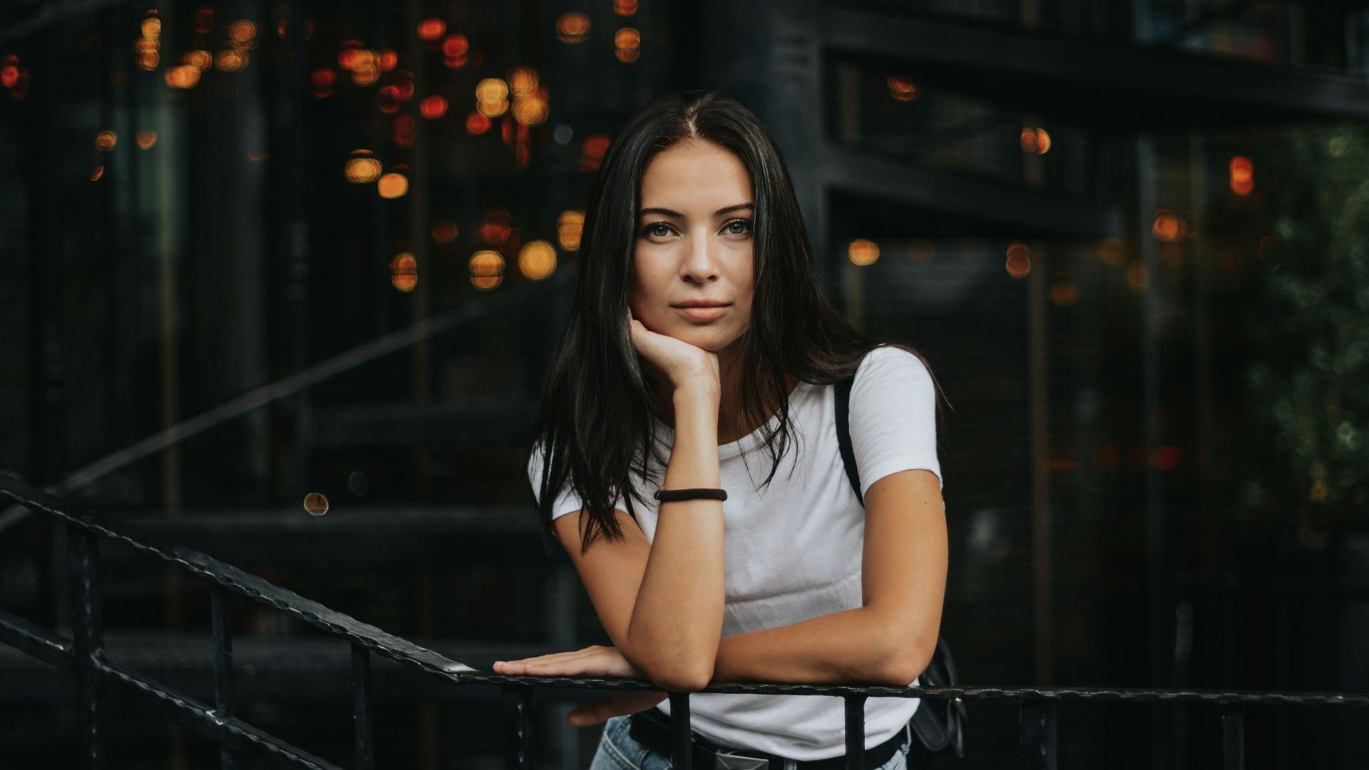 woman leaning on black handrail