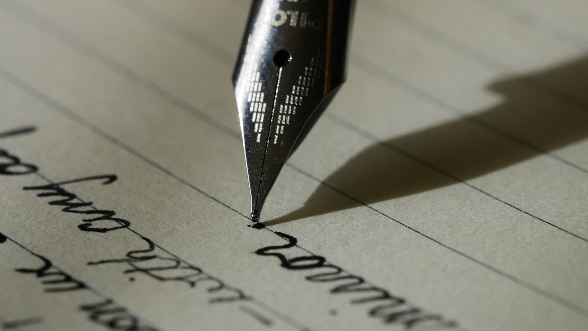 fountain pen on black lined paper