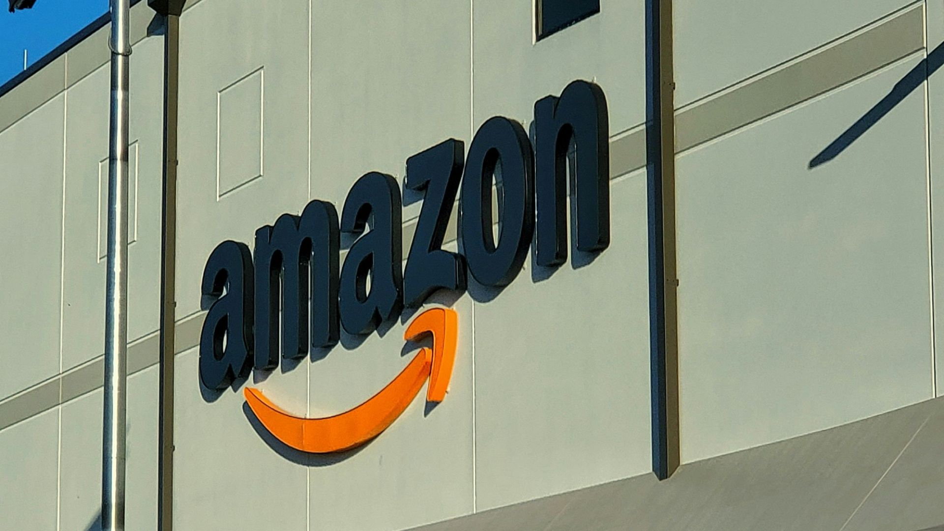 an amazon store with a person sitting in front of it