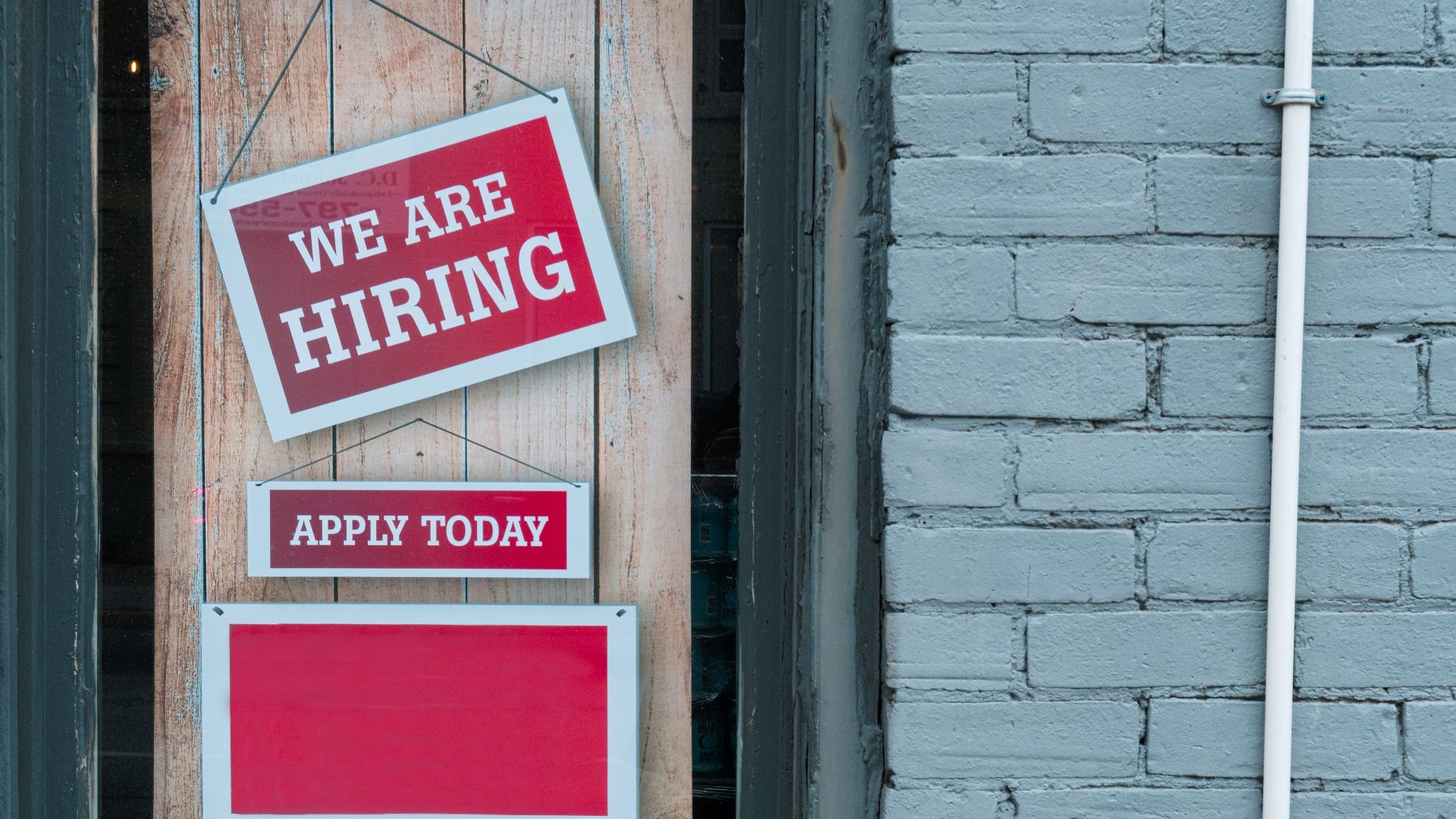 a sign that says we are hiring and apply today
