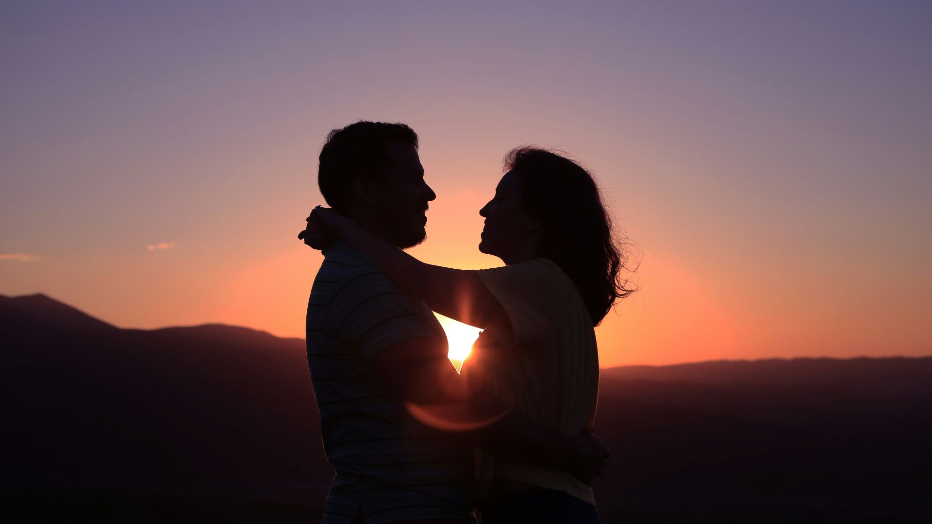 silhouette of hugging couple