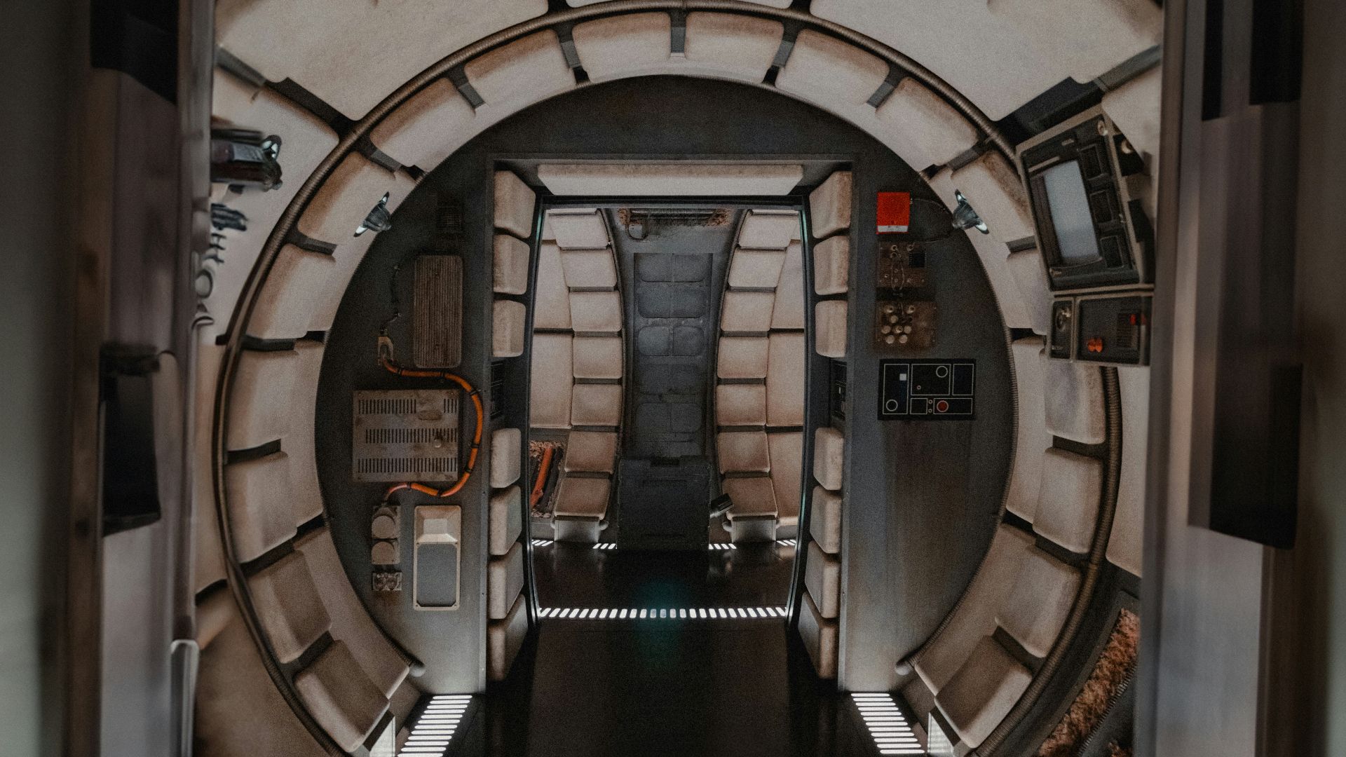 a hallway in a sci - fi style building with a door leading to another room