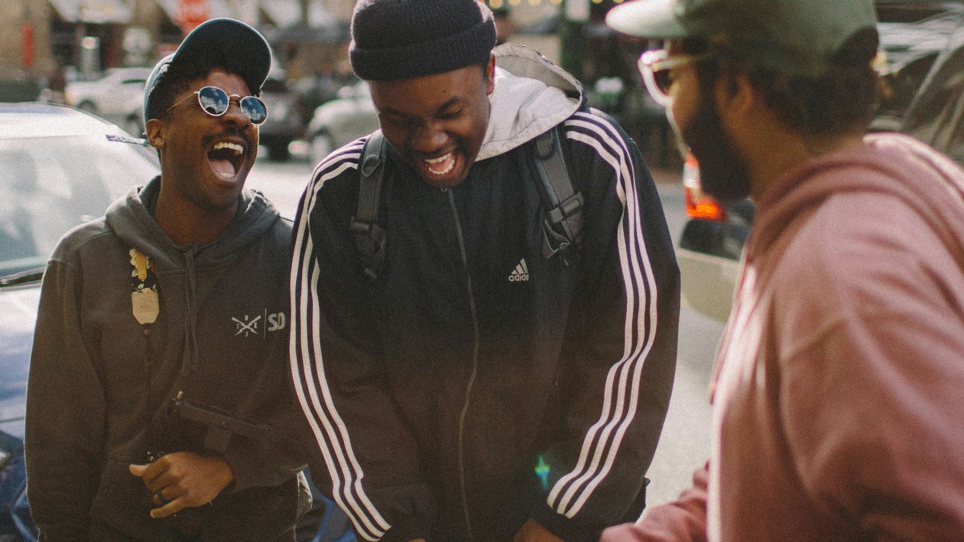 three men in jacket laughing at each other