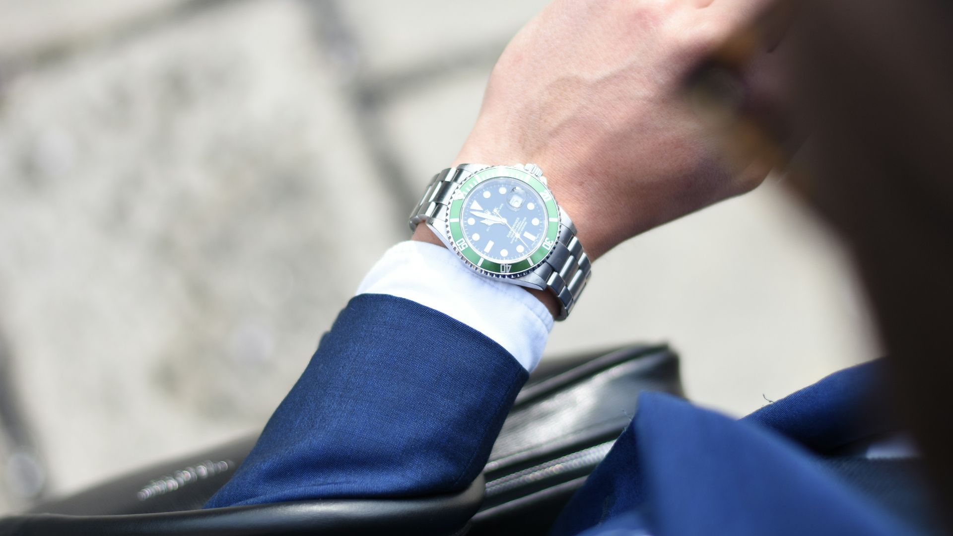 person looking at silver-colored analog watch