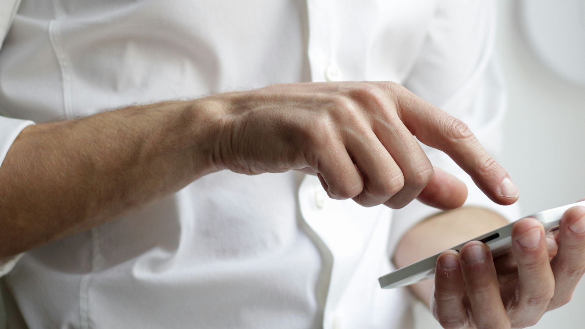 person holding white Android smartphone in white shirt