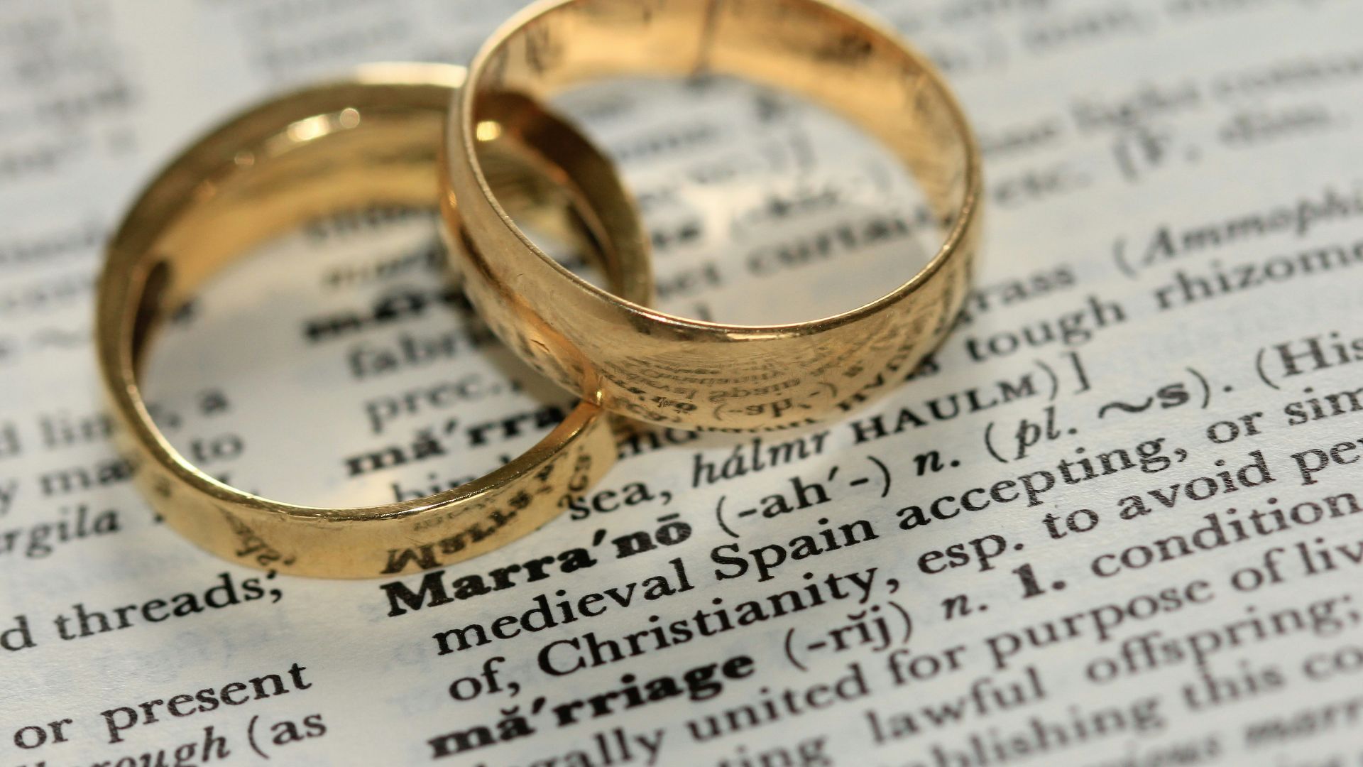 two gold-colored rings on paper