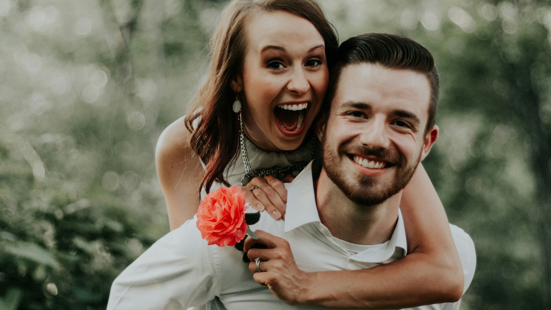 woman riding on back of man