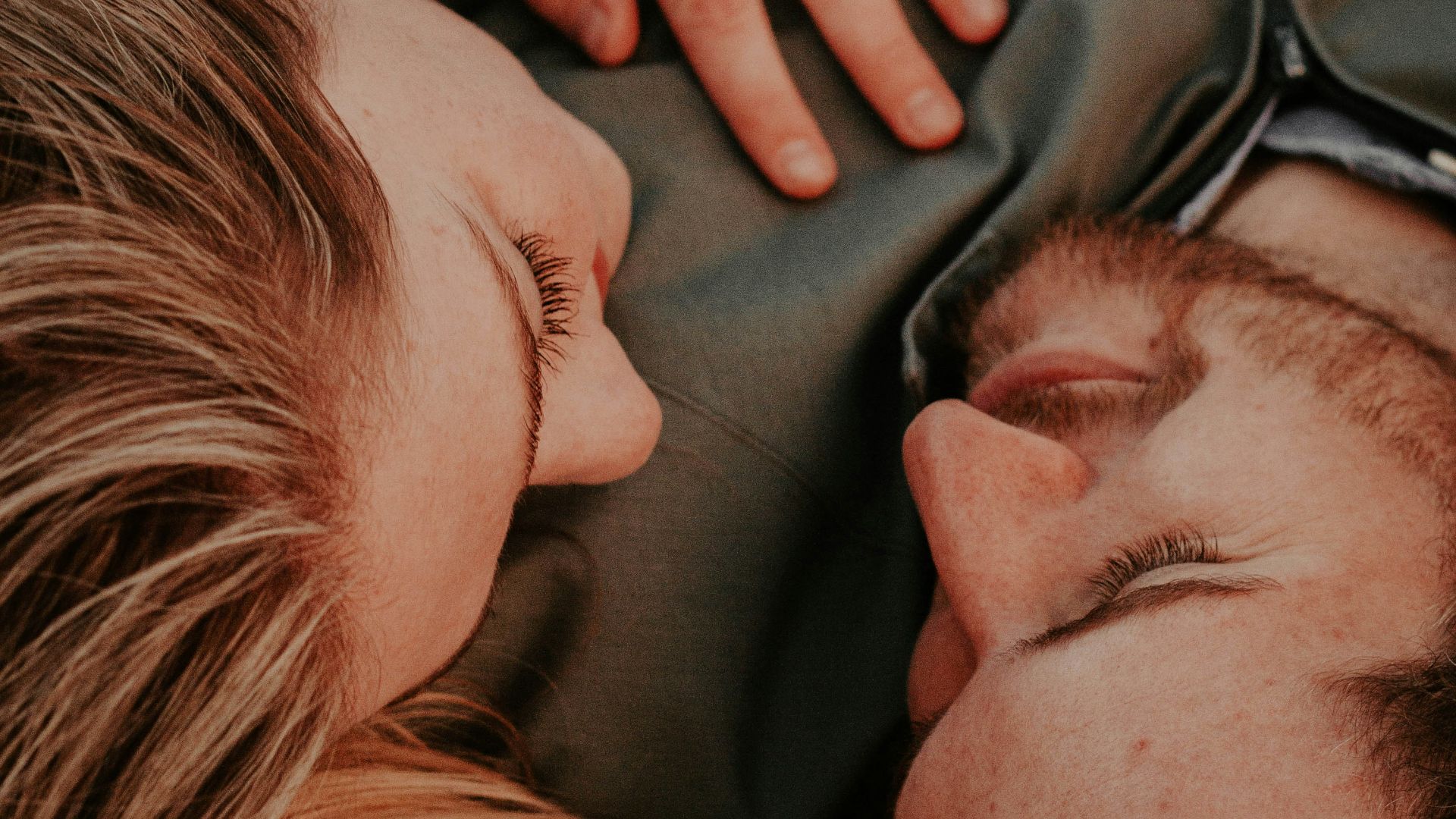 a woman stares into a man's eyes lovingly