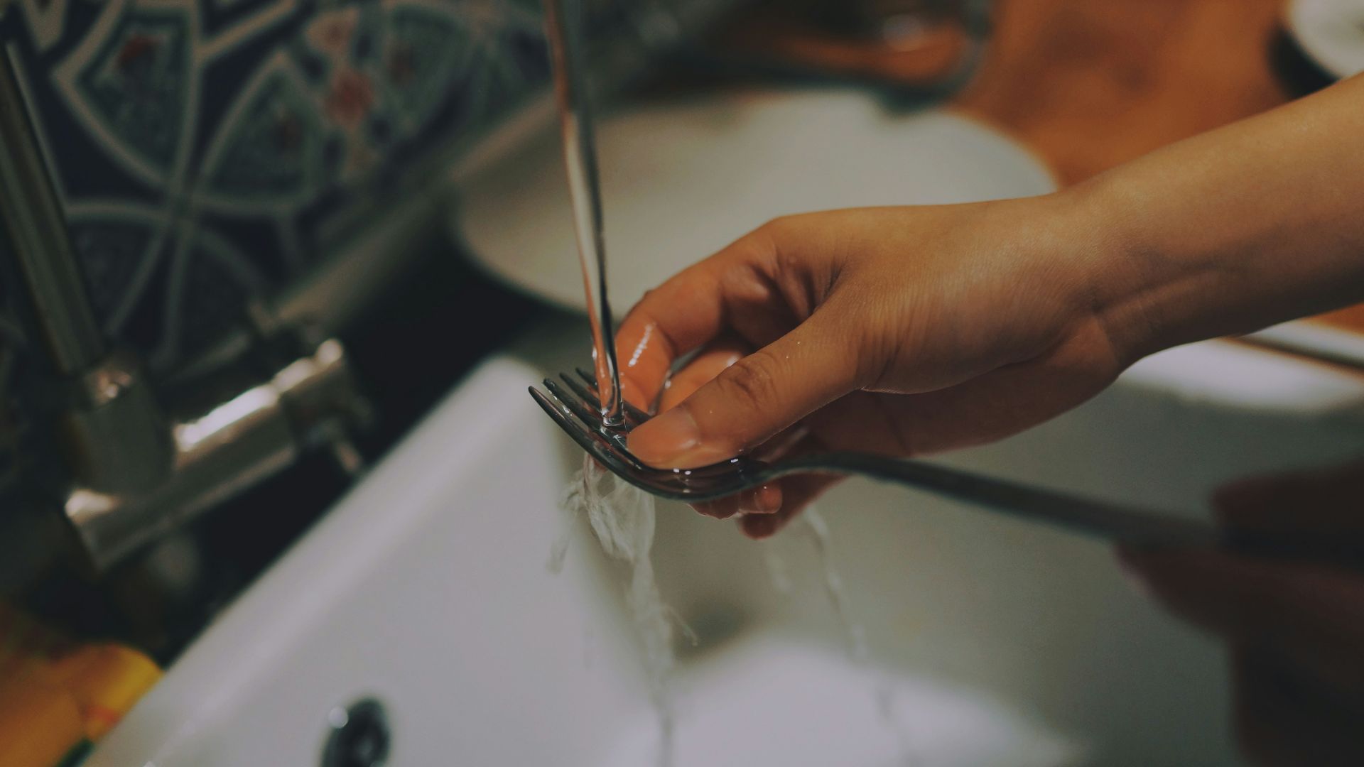 person washing fork