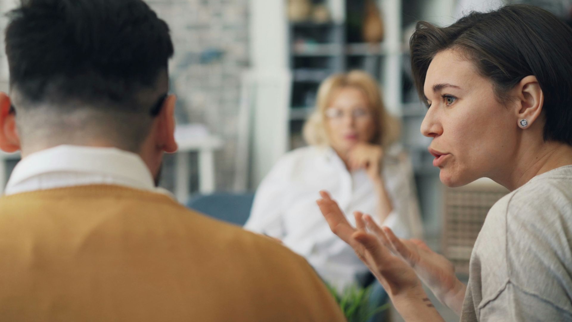 a woman talking to a man at a table