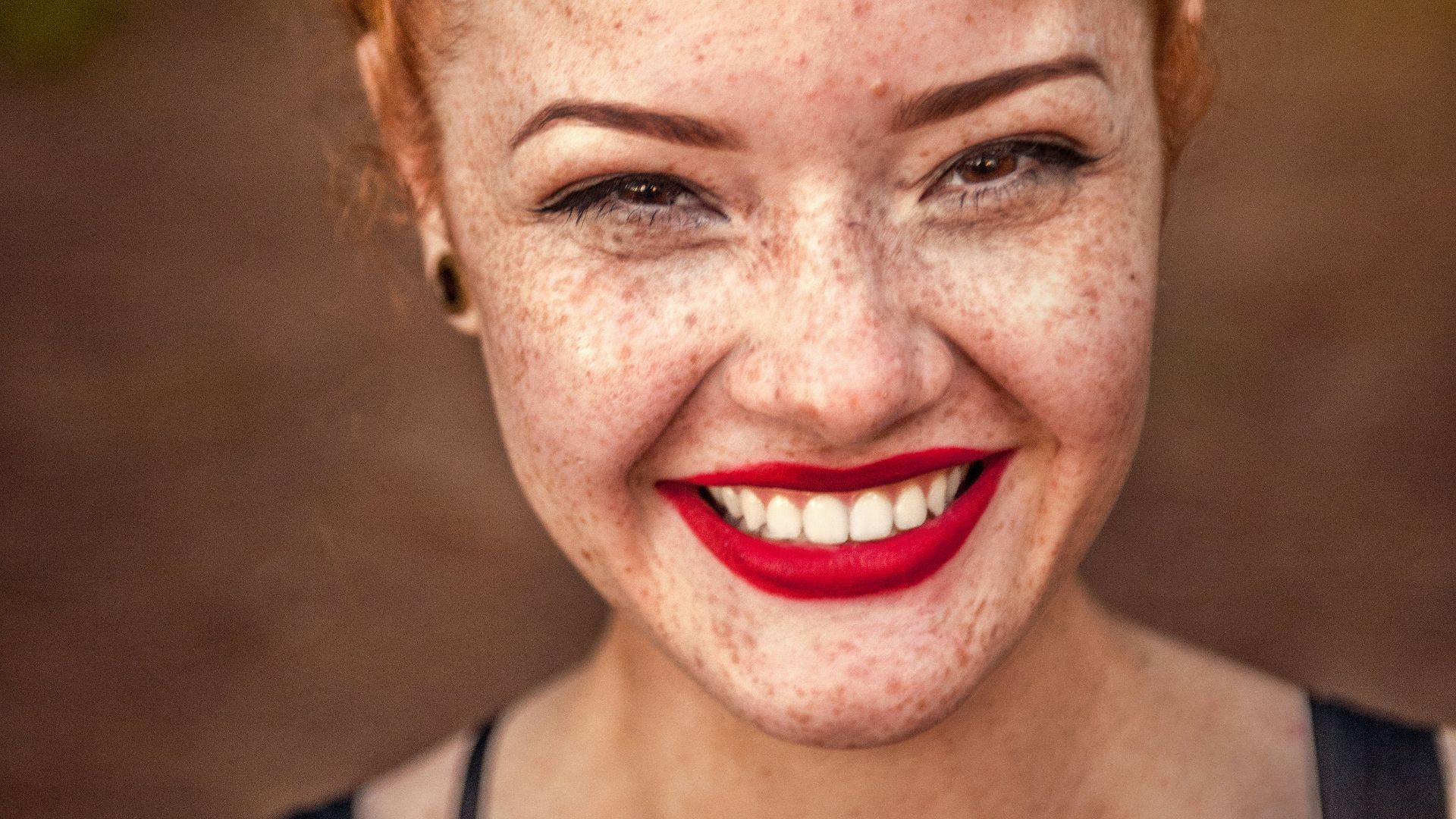 woman taking photo while showing smile