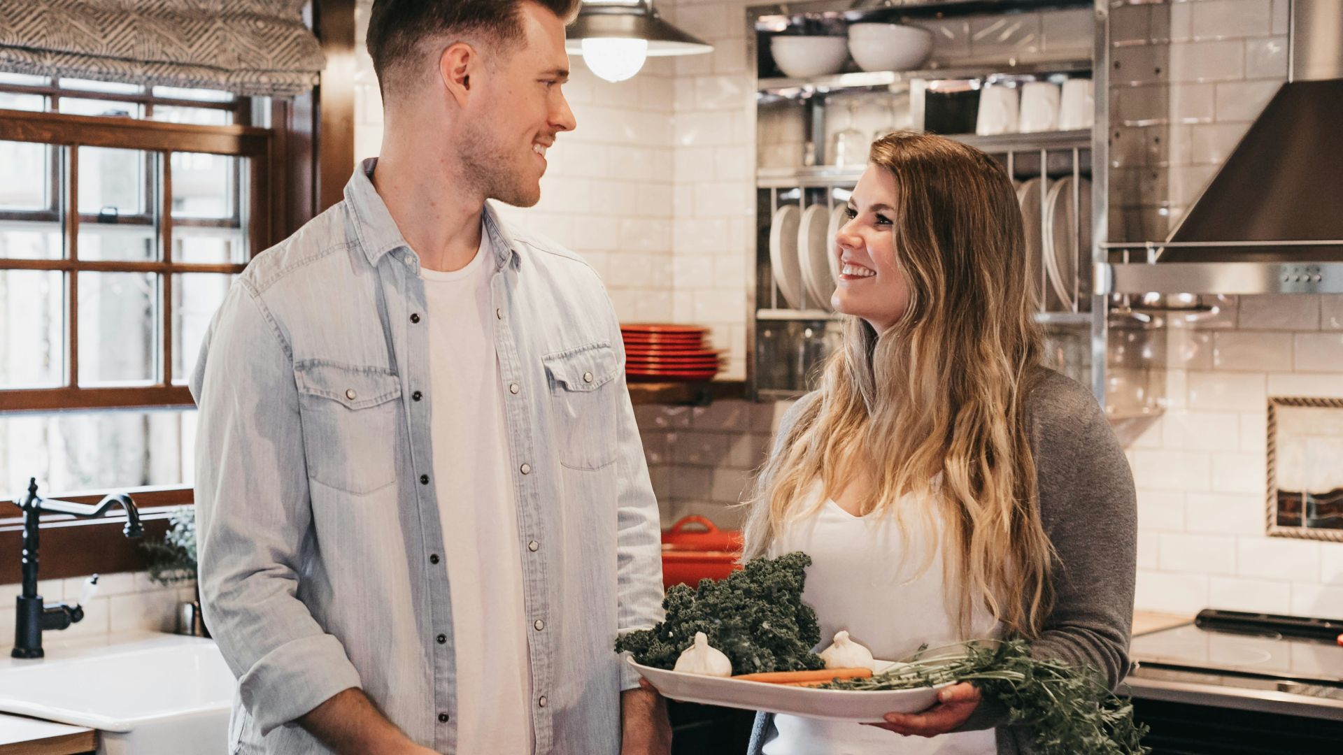 man and woman standing inside kitchen room