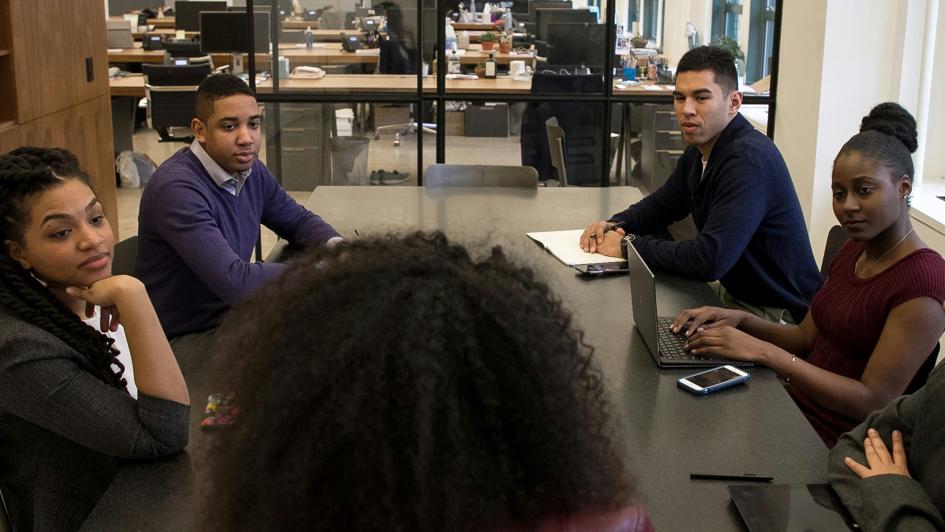 a group of people sitting around a table