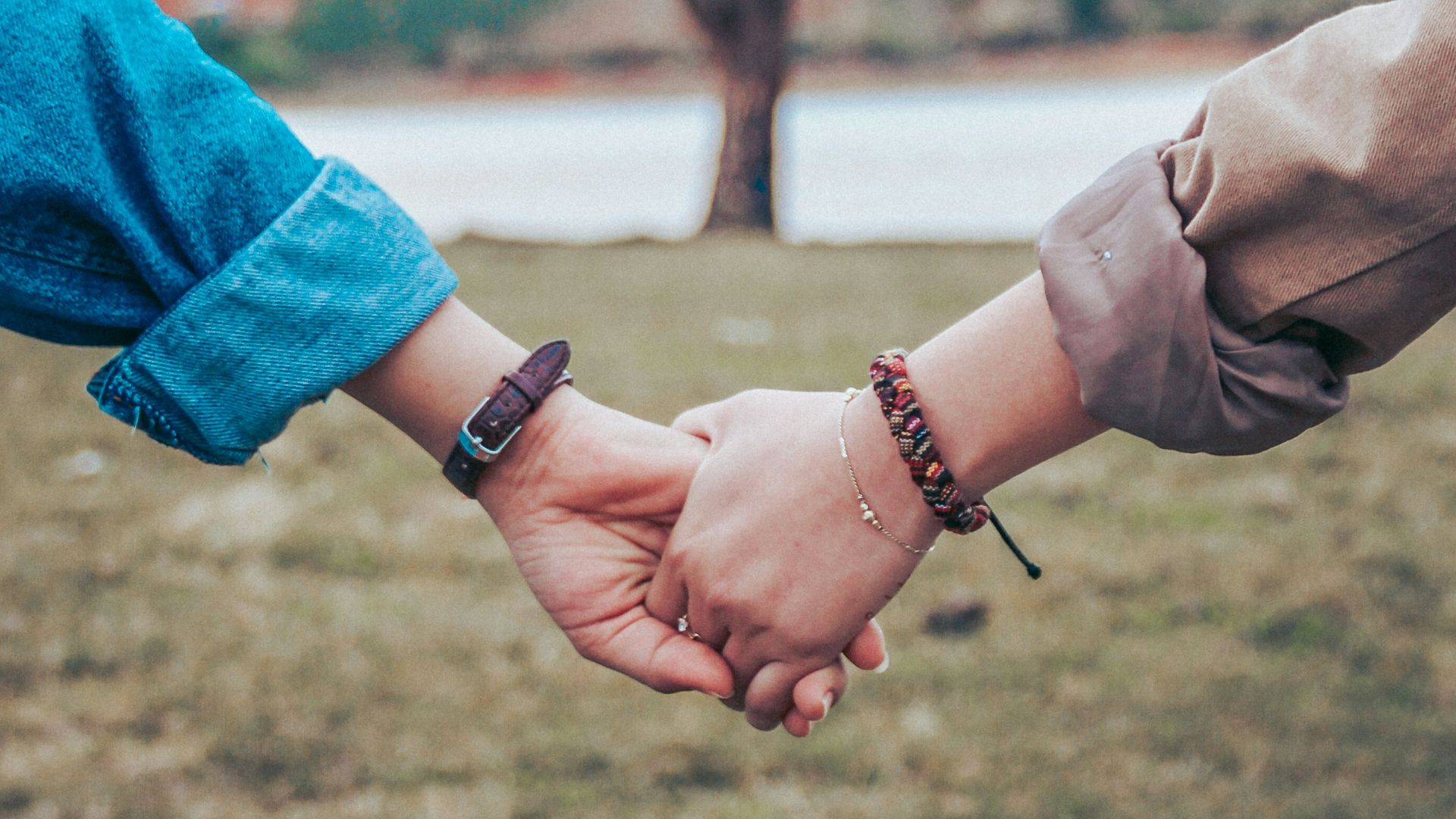 two persons holding hands