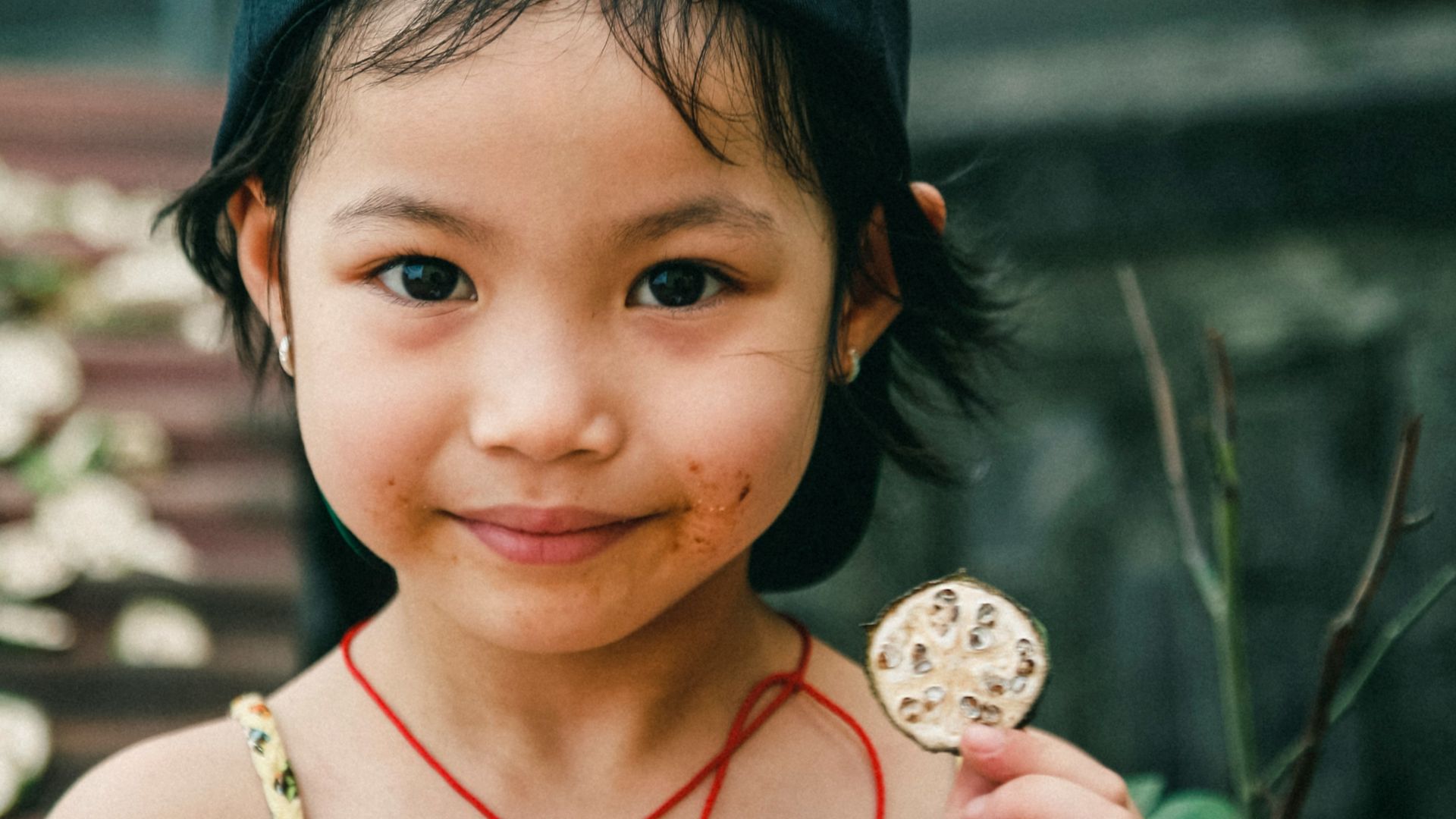portrait photography of girl holding round coin
