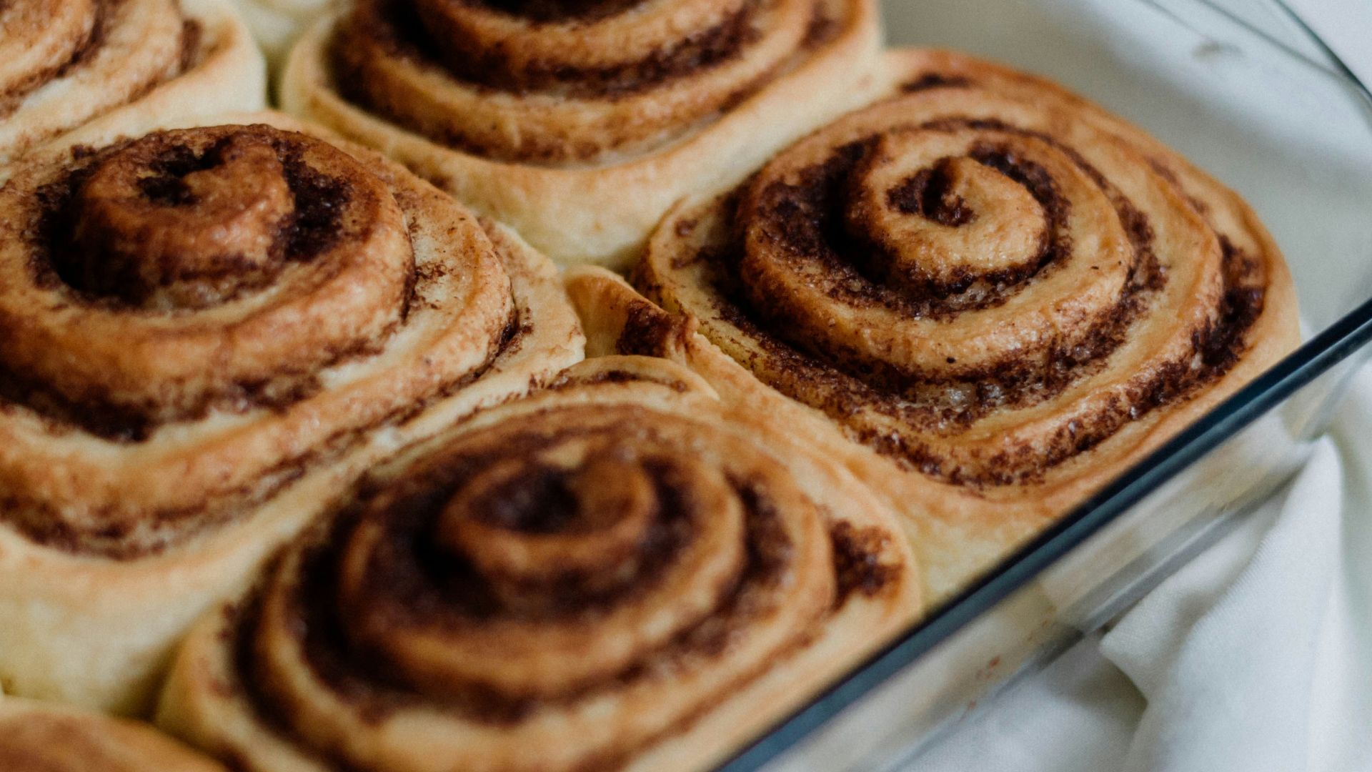 a pan filled with cinnamon rolls on top of a table