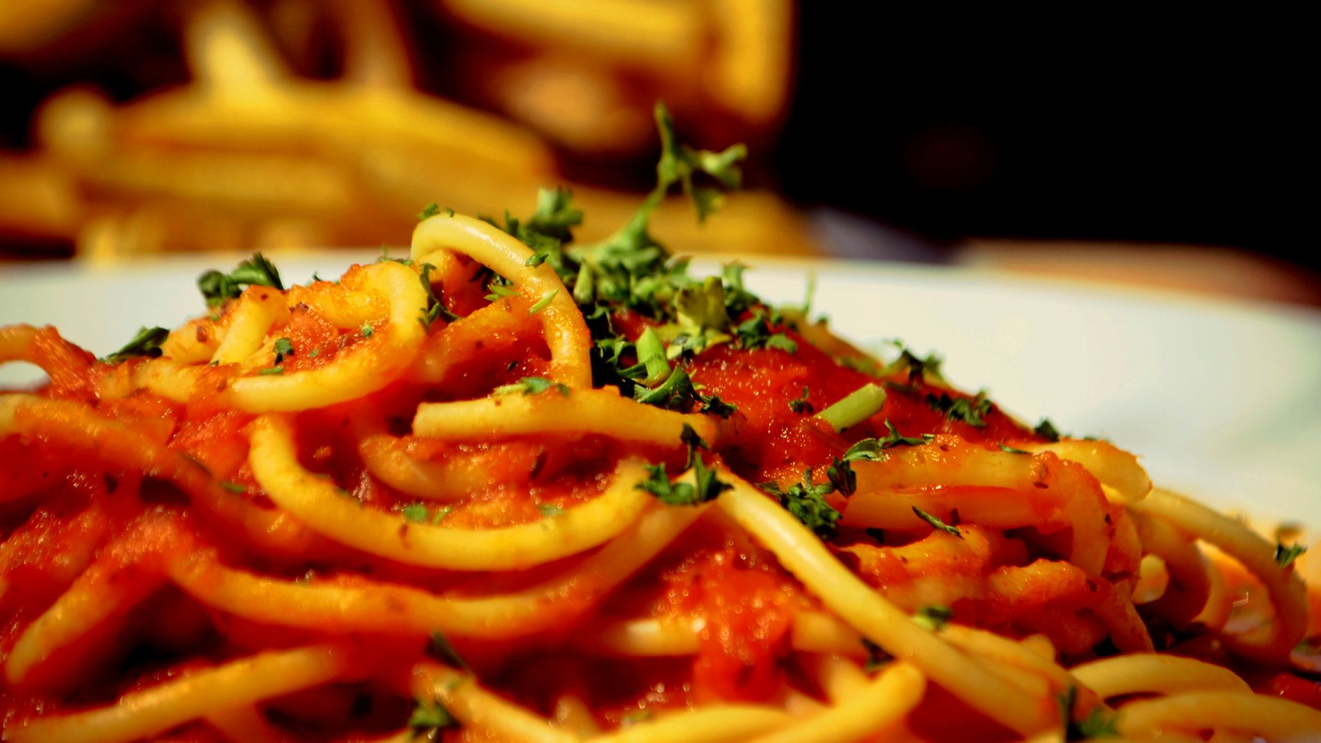 a plate of spaghetti with tomato sauce and parsley