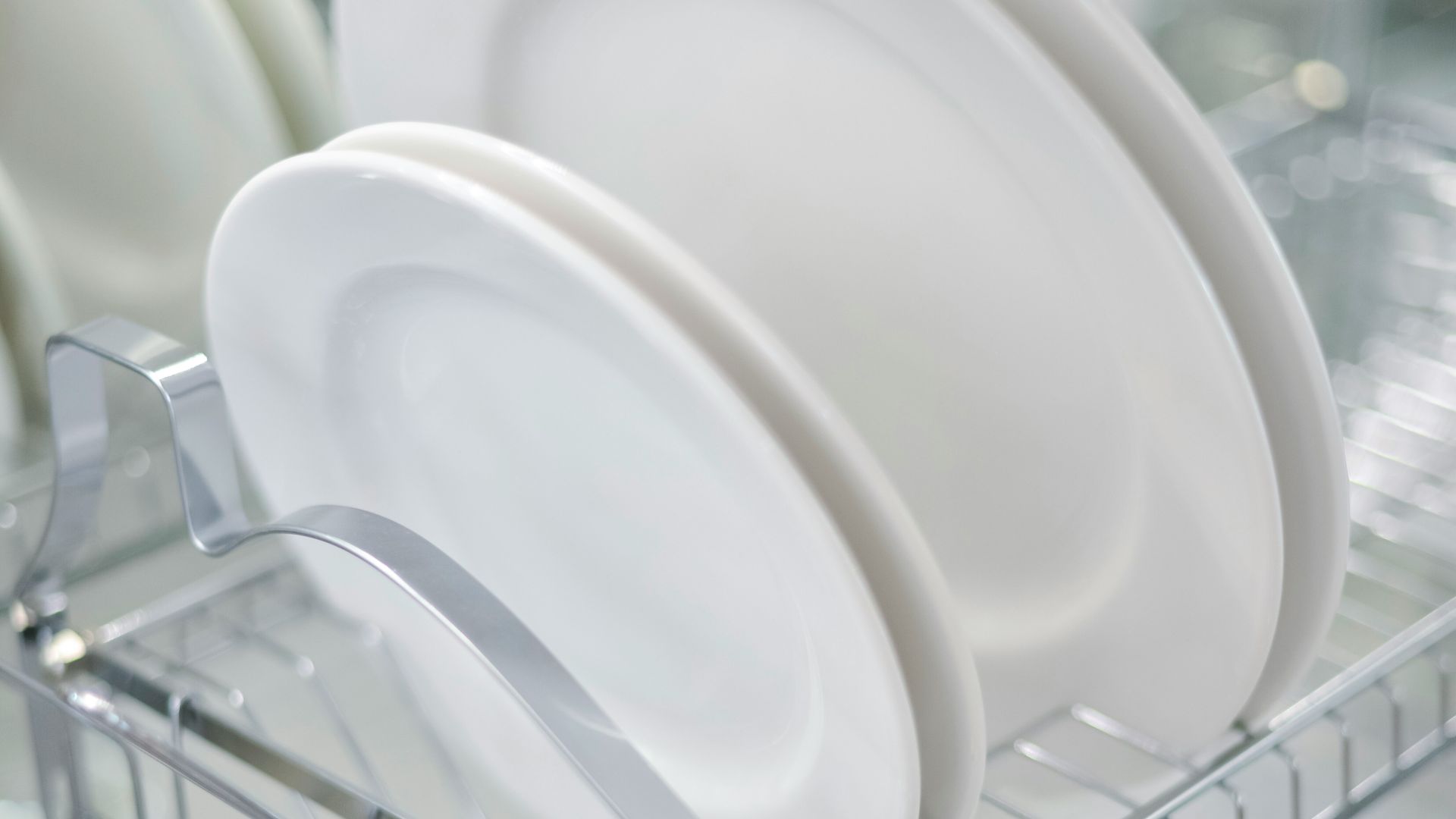 A rack with plates and cups in it