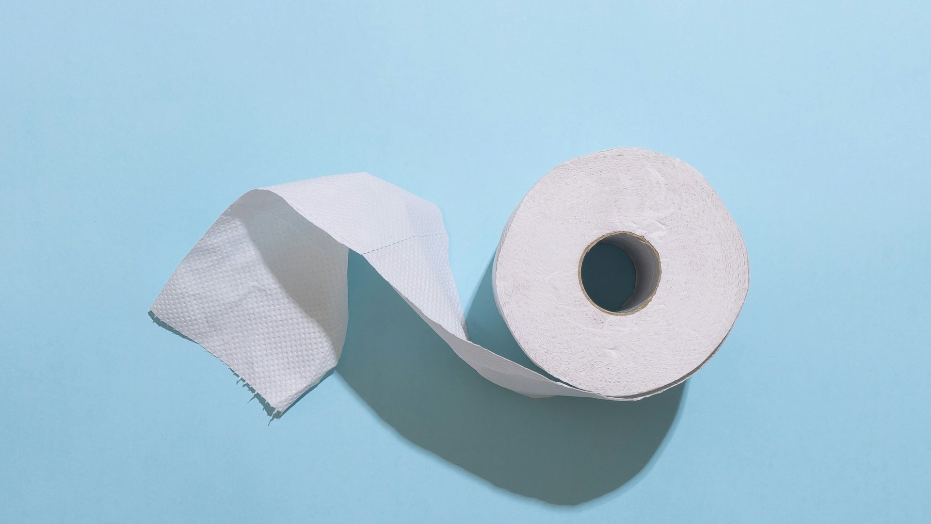 white toilet paper roll on white table