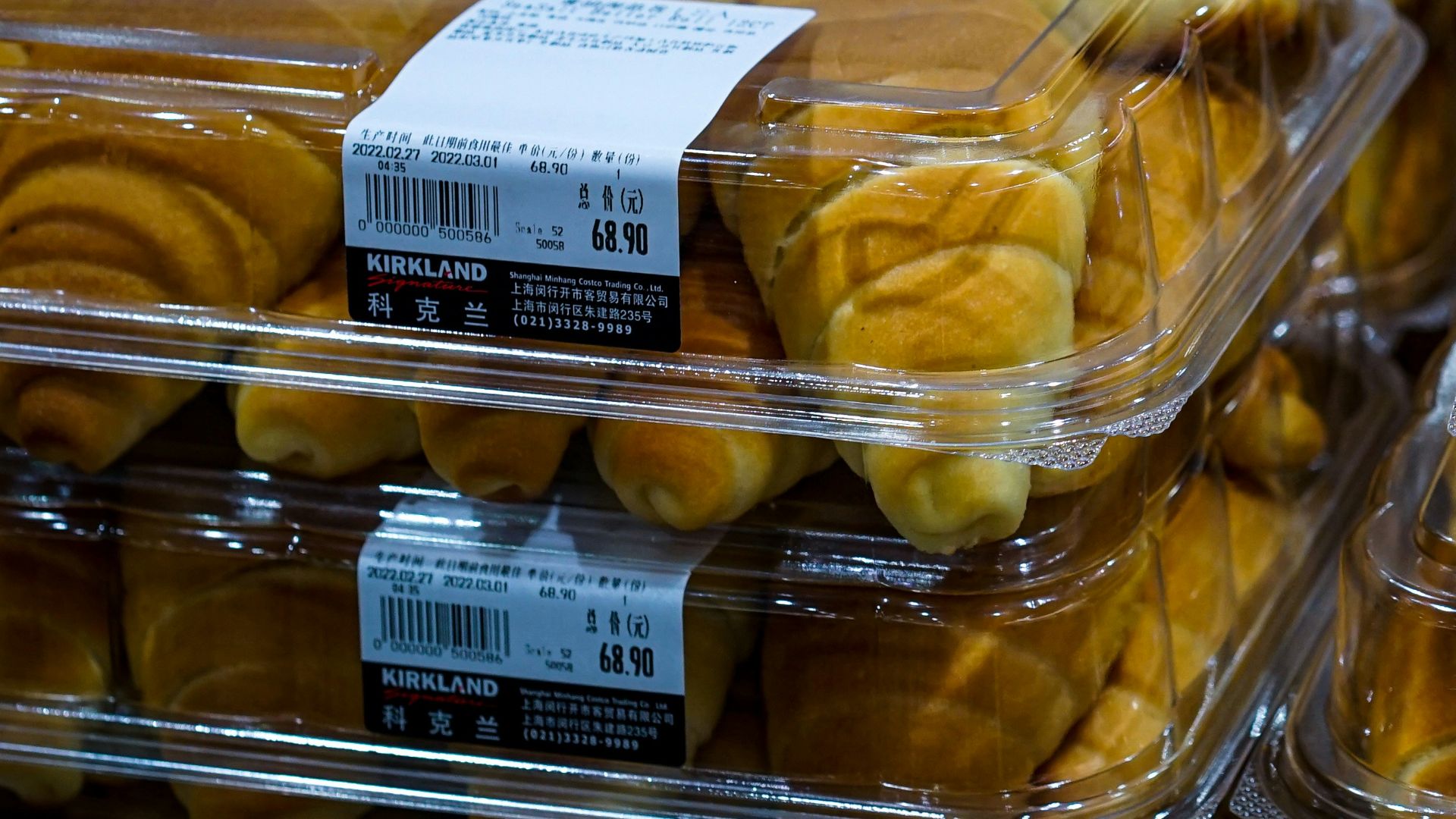 a close up of many pastries in plastic containers