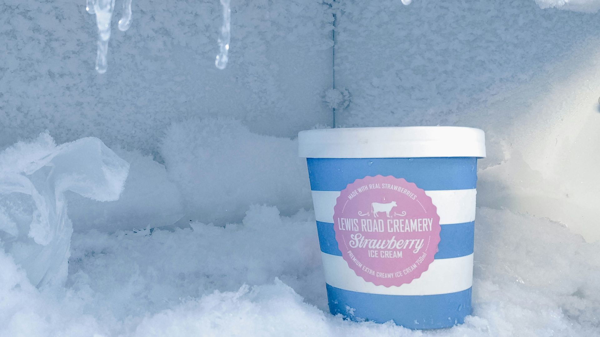 strawberry ice cream bottle inside container covered in ice