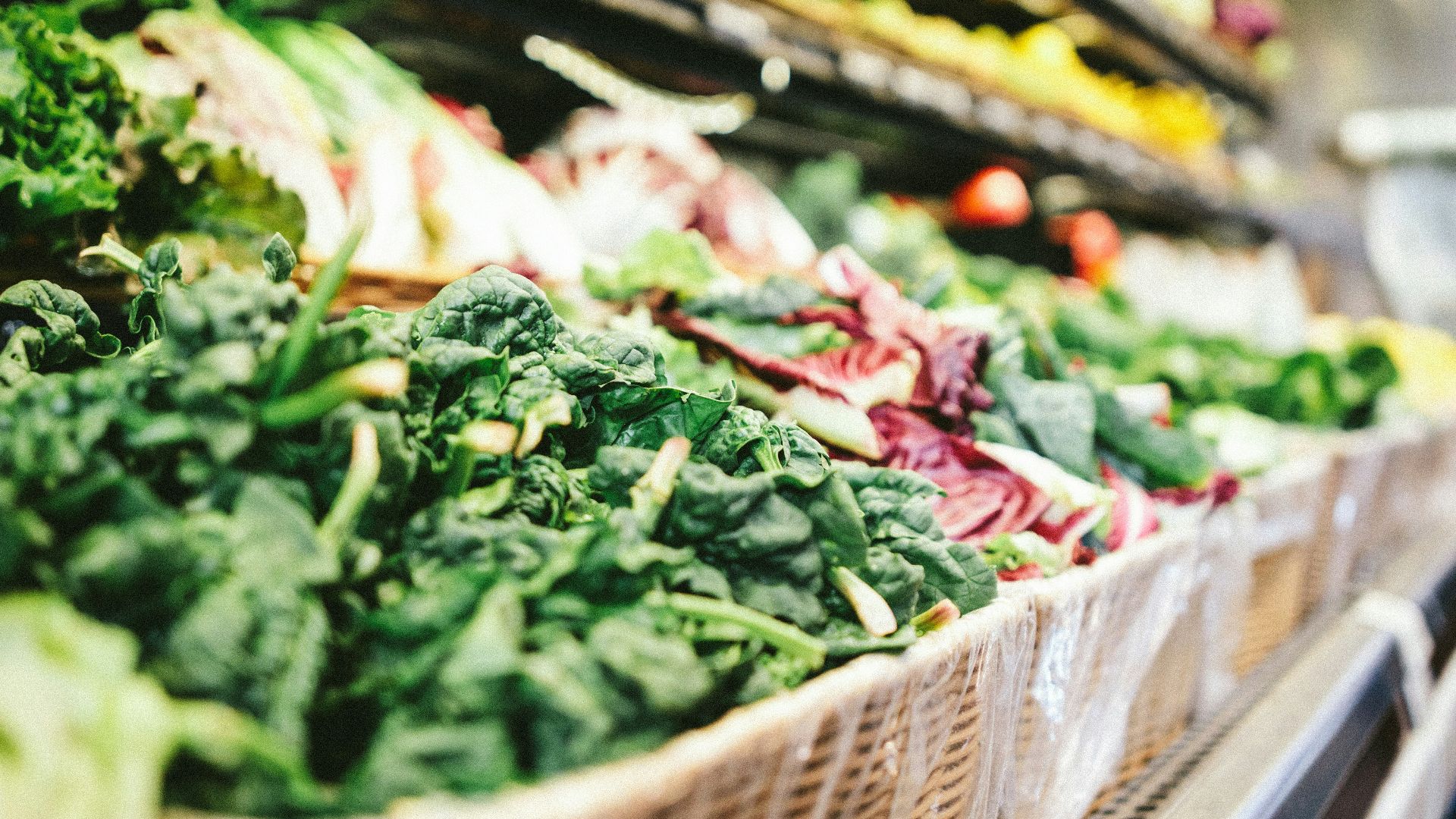 row of vegetables placed on multilayered display fridge