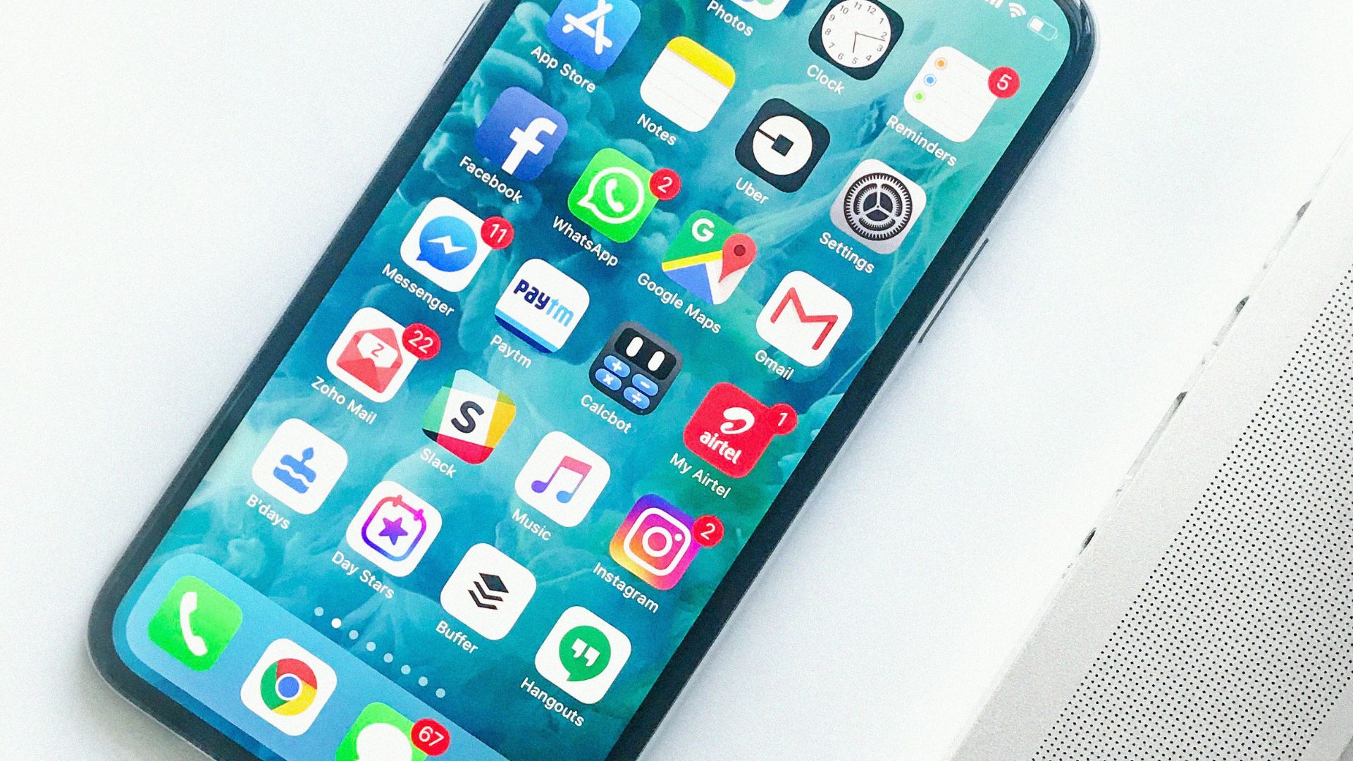 white smartphone near laptop