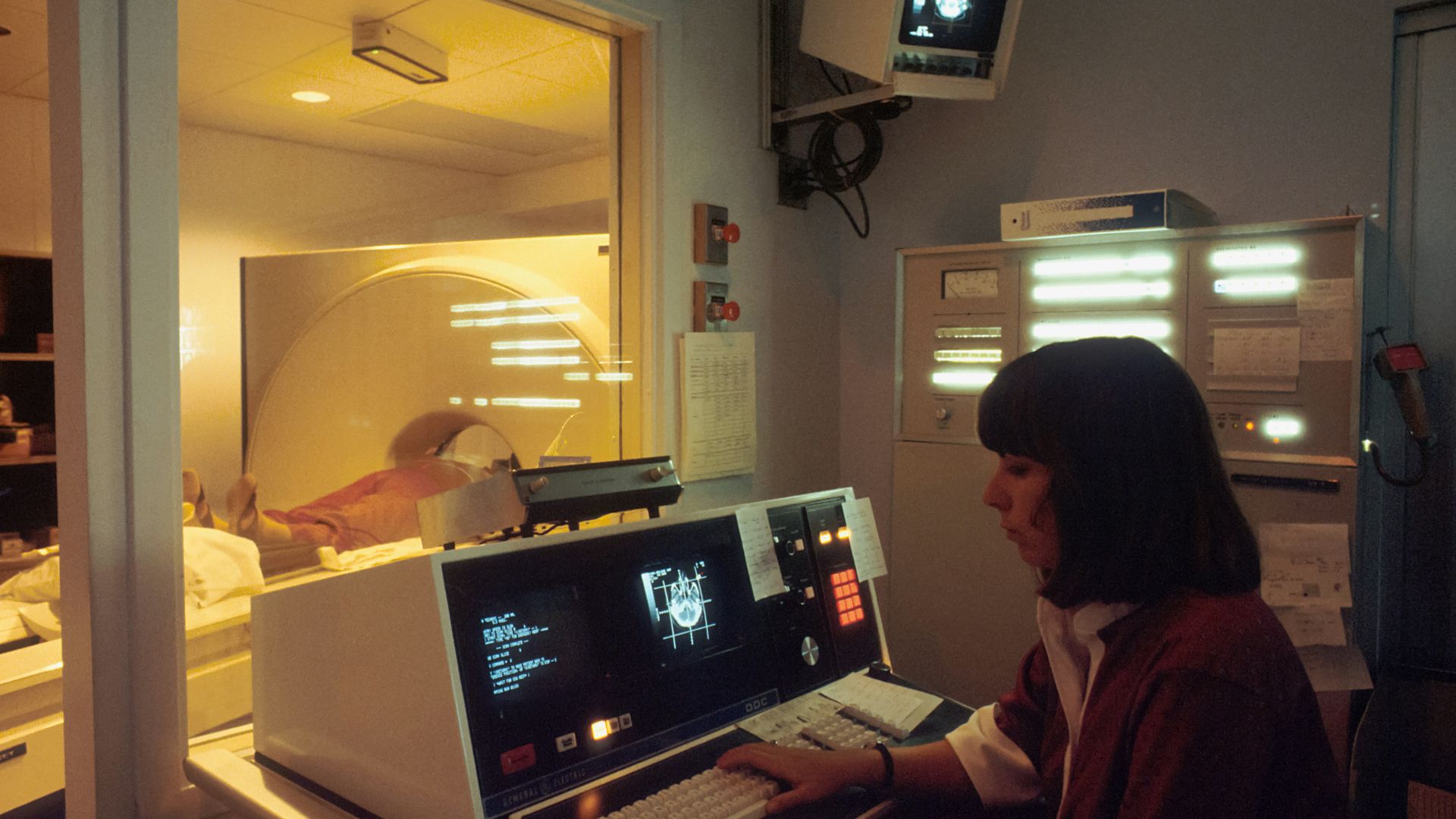 a woman sitting in front of a laptop computer