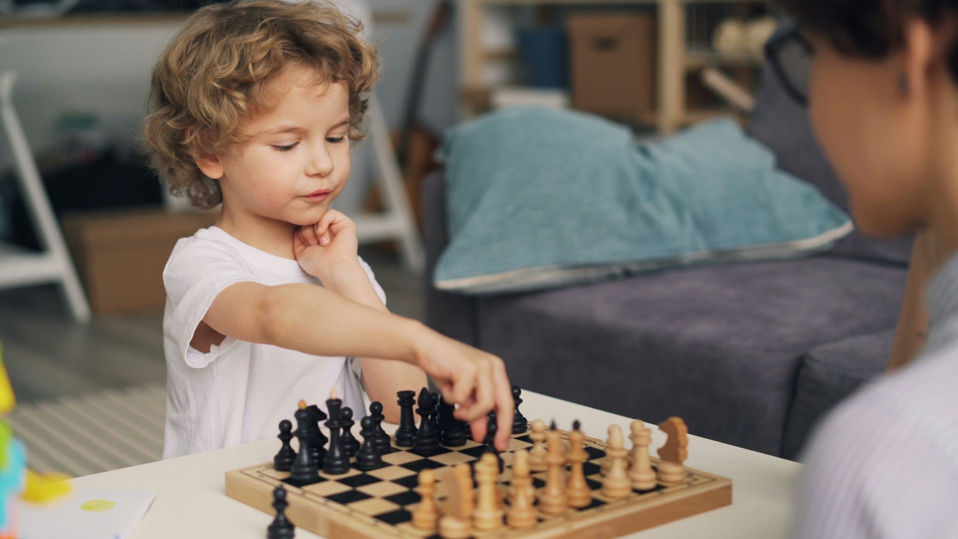 a little boy playing a game of chess