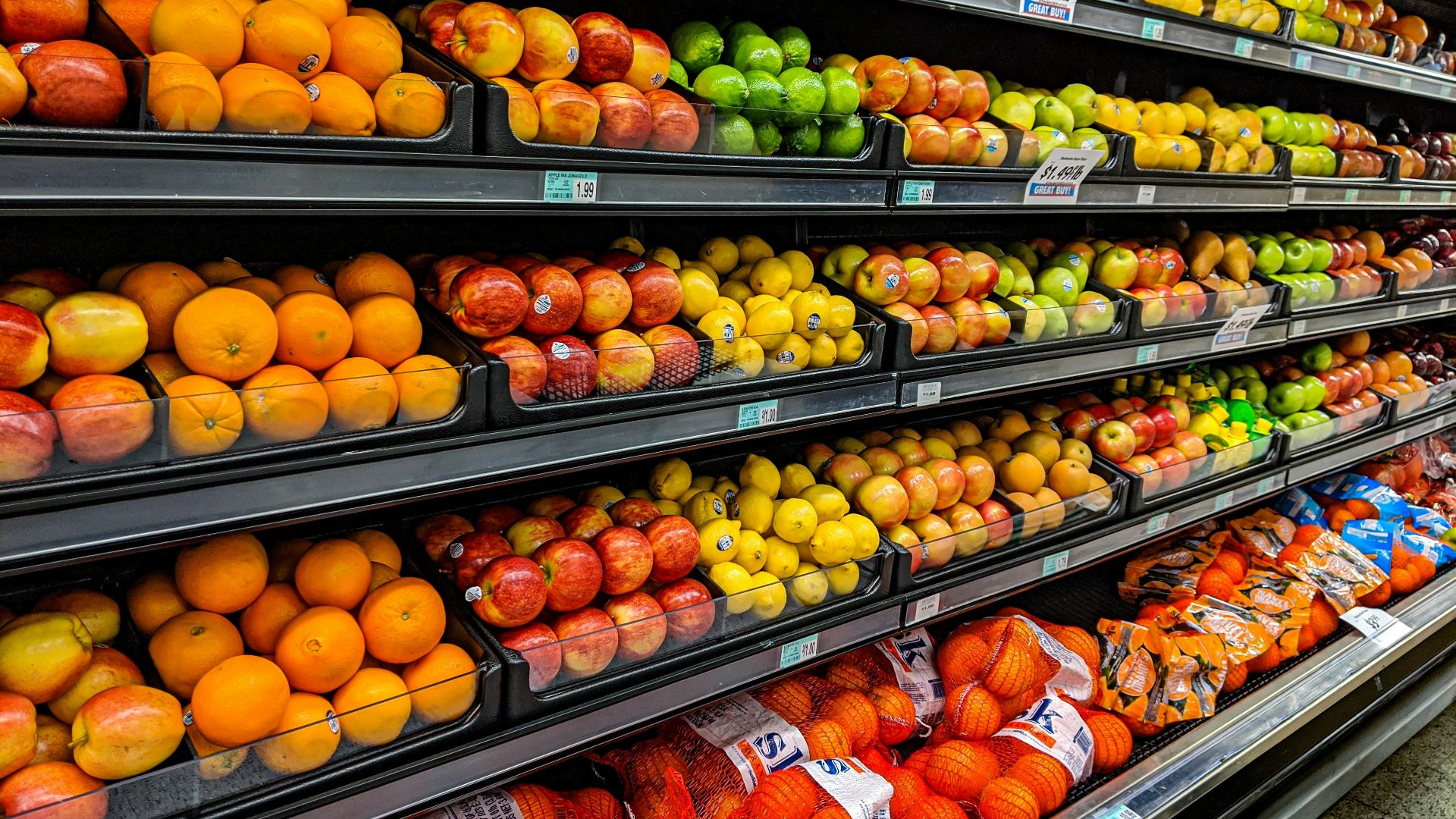 yellow and red apples on black plastic crate