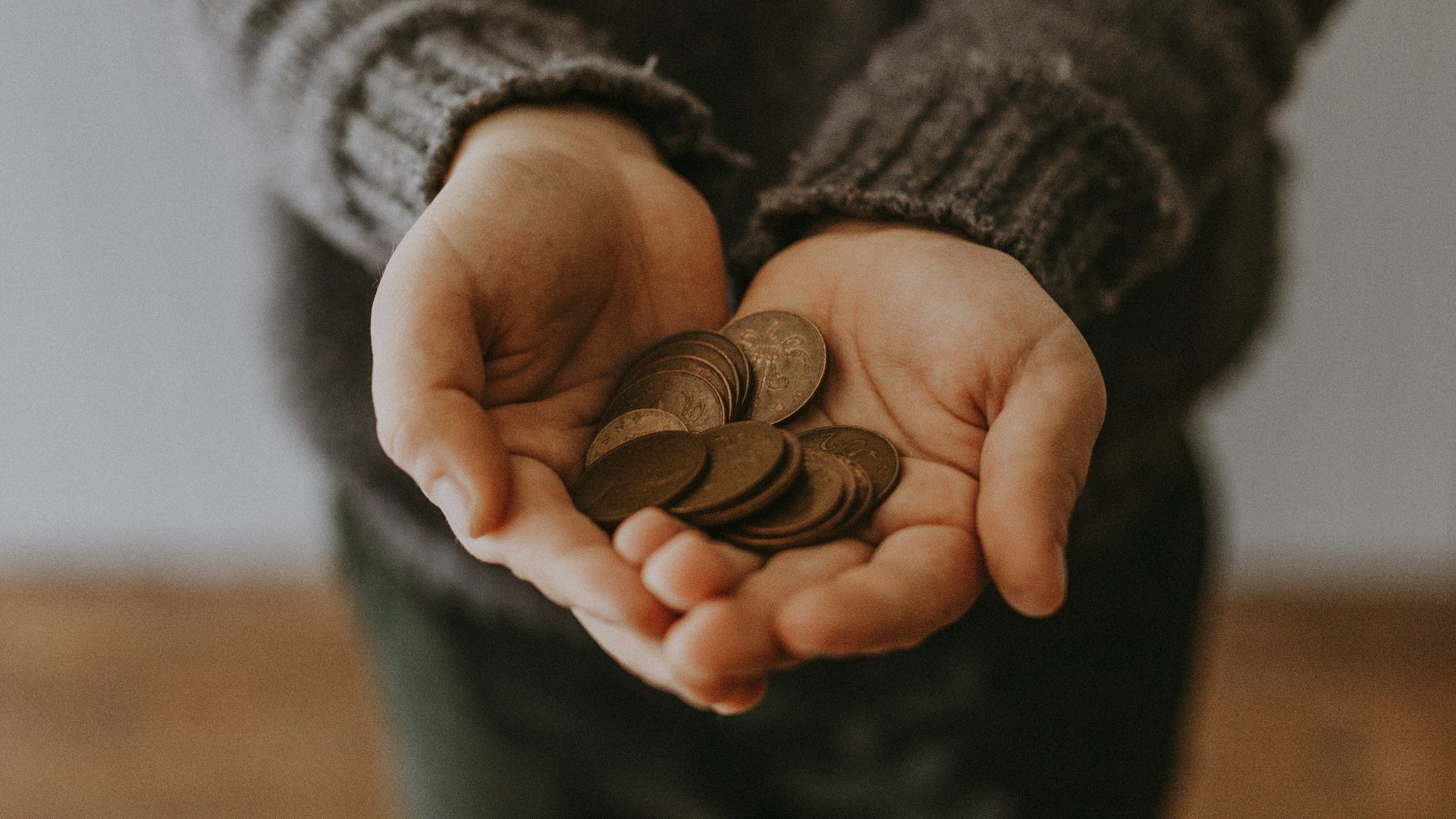 copper-colored coins on in person's hands