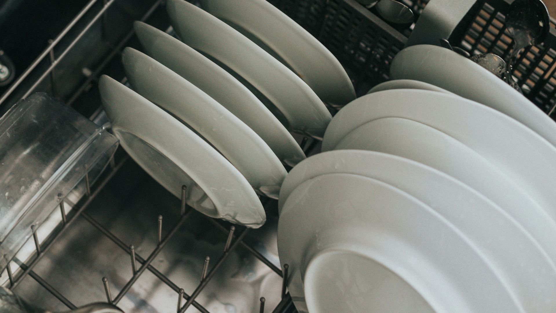 white ceramic plate on black dishwasher